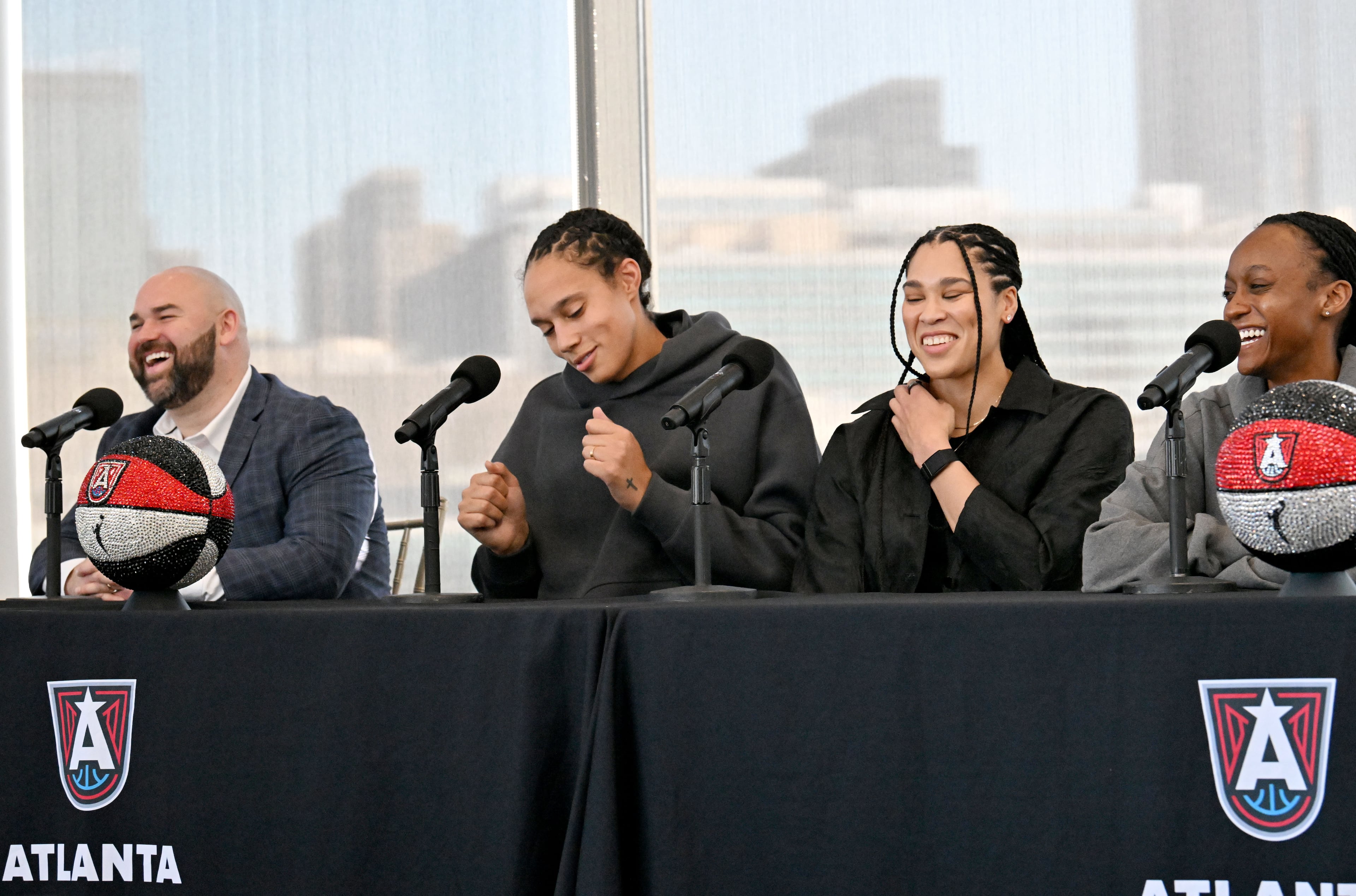 Atlanta Dream’s Brittney Griner shows some dance moves as Brionna Jones and Shatori Walker-Kimbrough (right) react during a press conference. (Hyosub Shin / AJC)