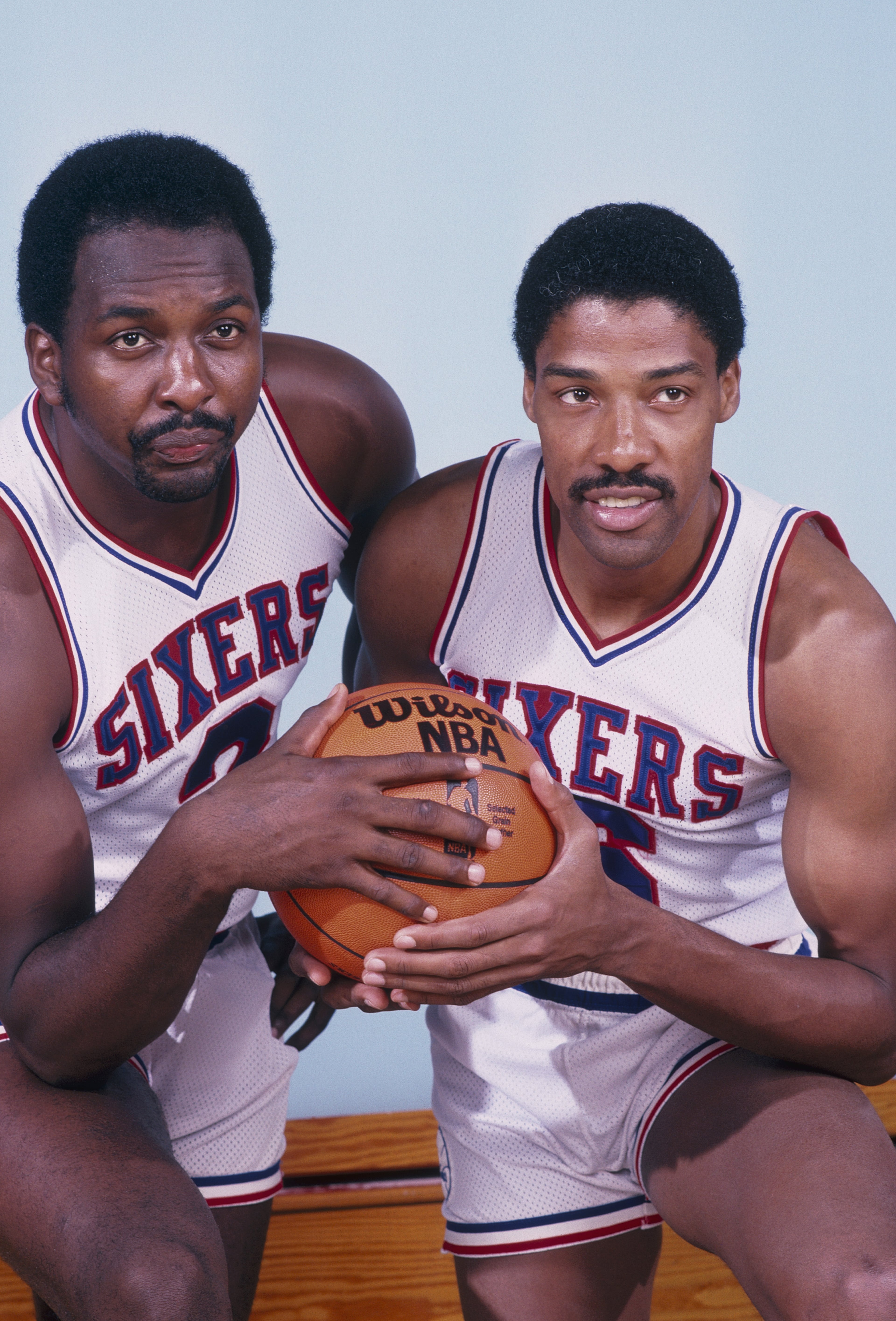 1982: Moses Malone #2 (left) and Julius Erving #6 of the Philadelphia 76ers pose for a photo during the 1982 NBA season. (Photo by Rick Stewart/Getty Images)