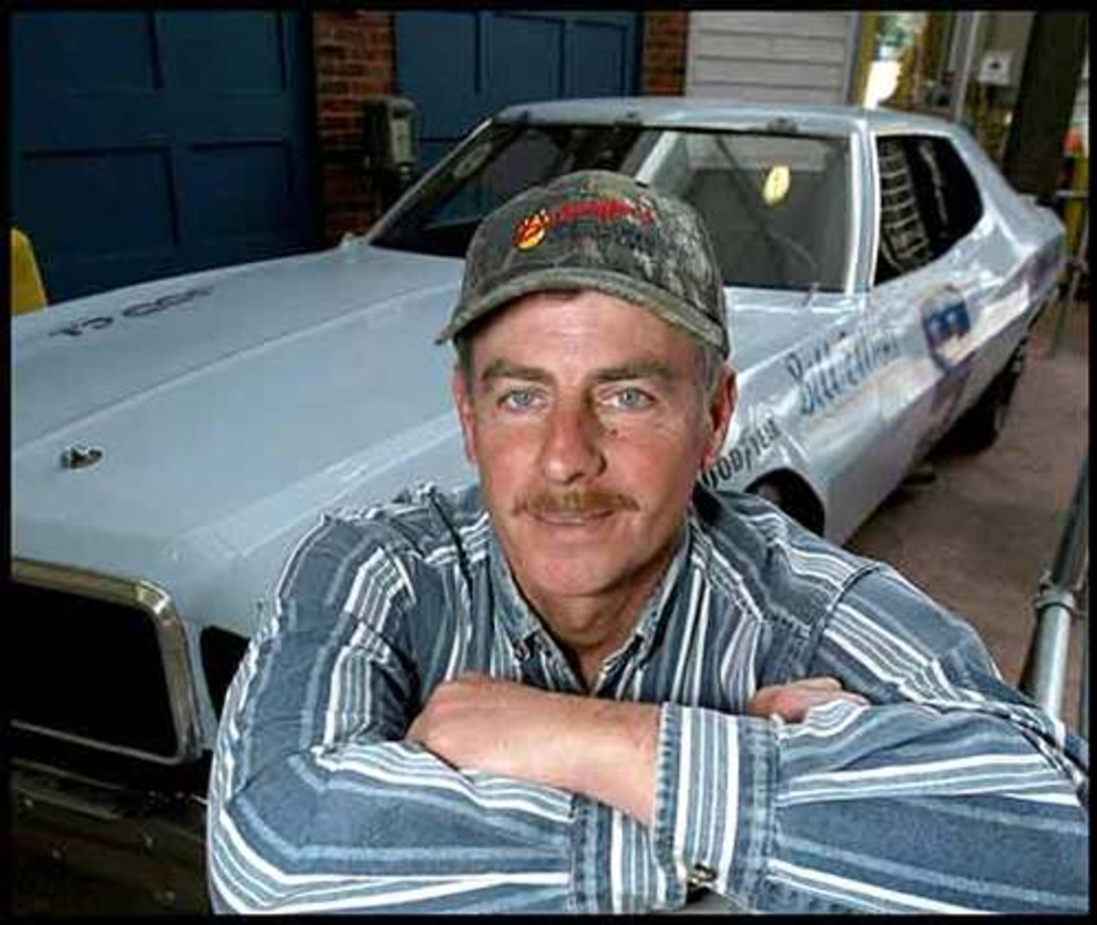 David Sosebee ran the 500 in 1987. He blew a tire entering Turn 3 on his qualifying lap at 203 miles per hour, but still fast enough on the first lap to get in the race. He poses in front of Bill Elliott's 1973 Ford Grand Torino inside the Georgia Racing Hall of Fame in Dawsonville.
