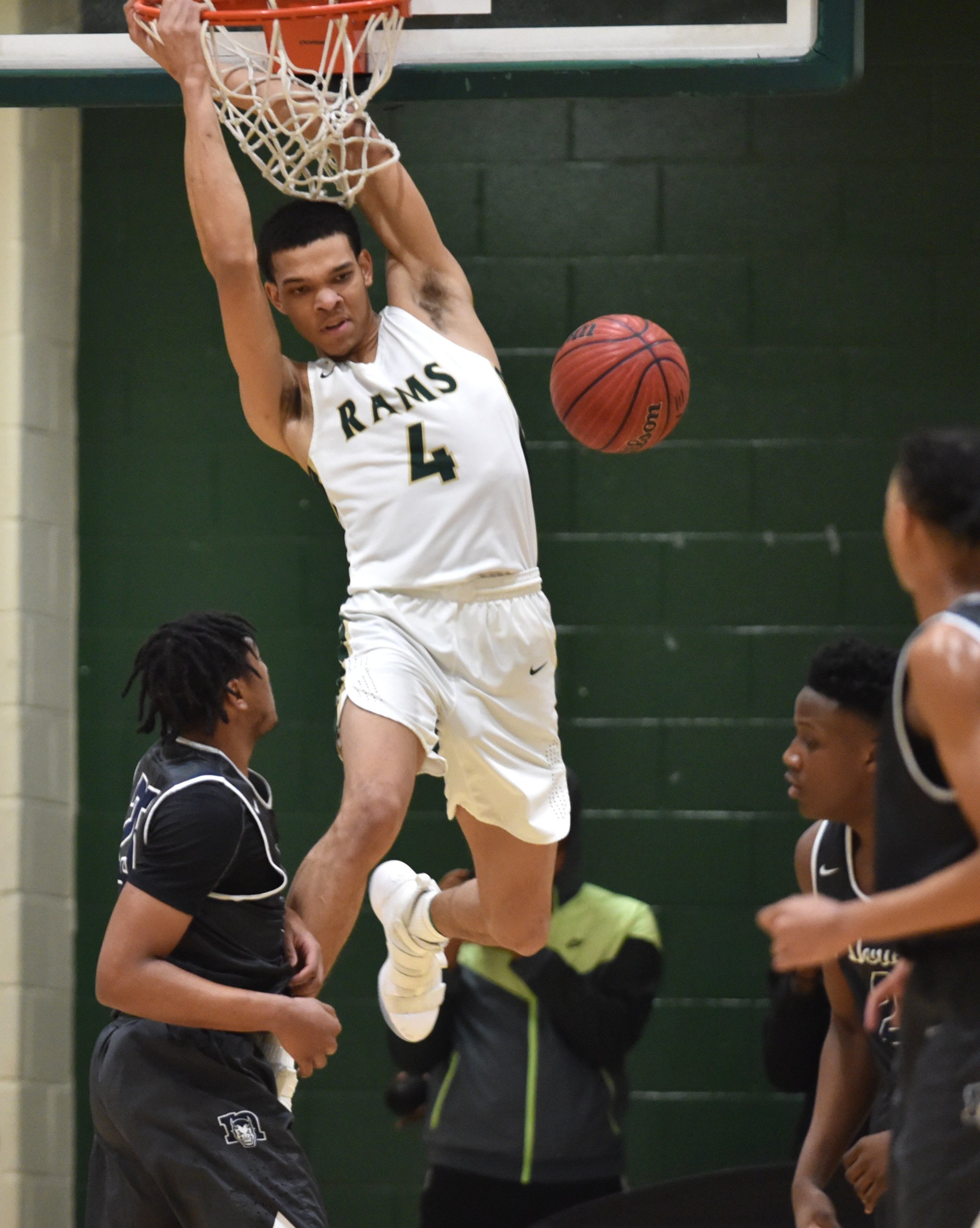 Grayson's Kenyon Jackson (4) hangs on the basket after a dunk. (Hyosub Shin/hshin@ajc.com)