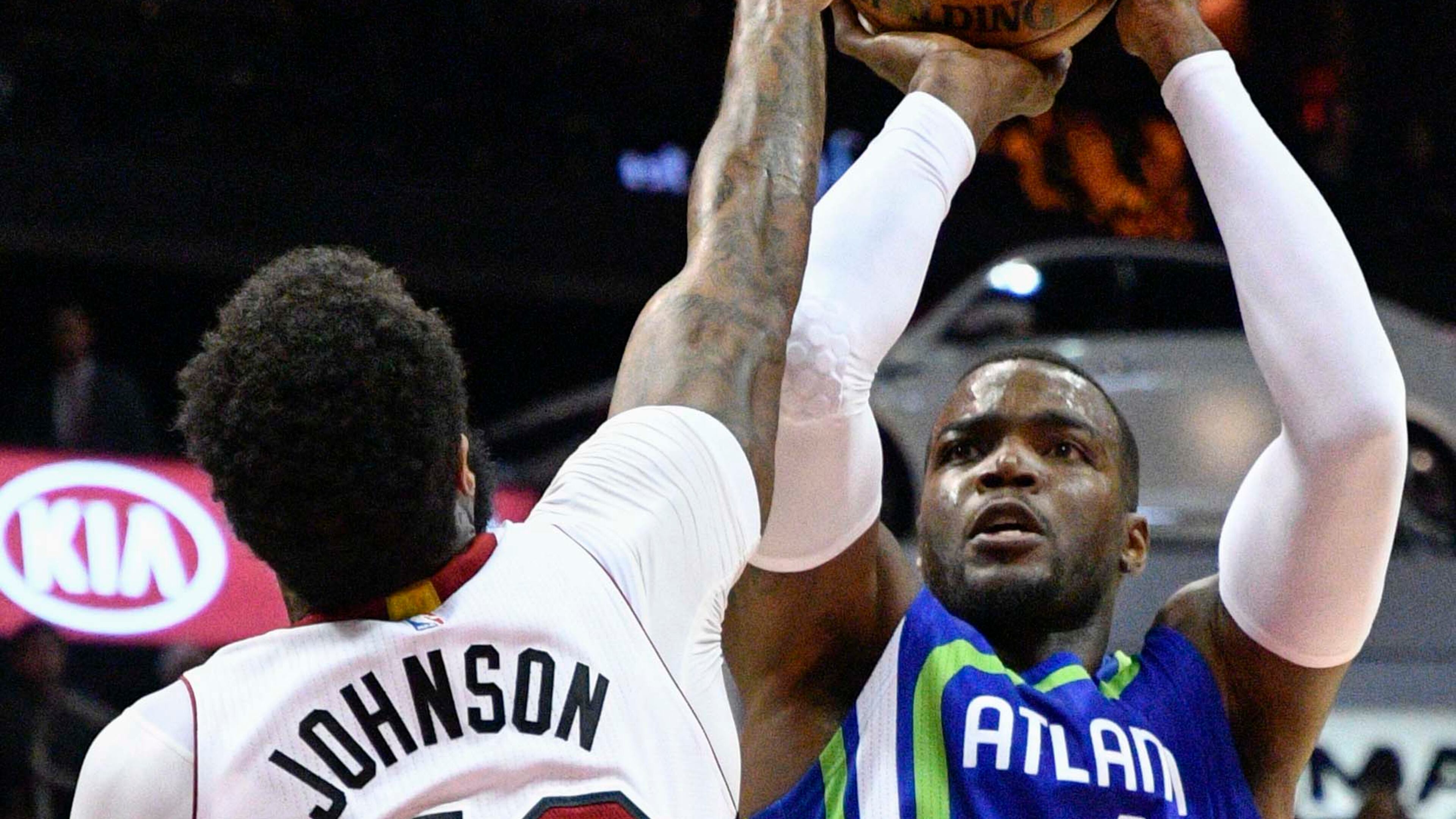 Atlanta Hawks forward Paul Millsap shoots as Miami Heat forward James Johnson defends during the first half of an NBA basketball game, Friday, Feb. 24, 2017, in Atlanta. (AP Photo/John Amis)
