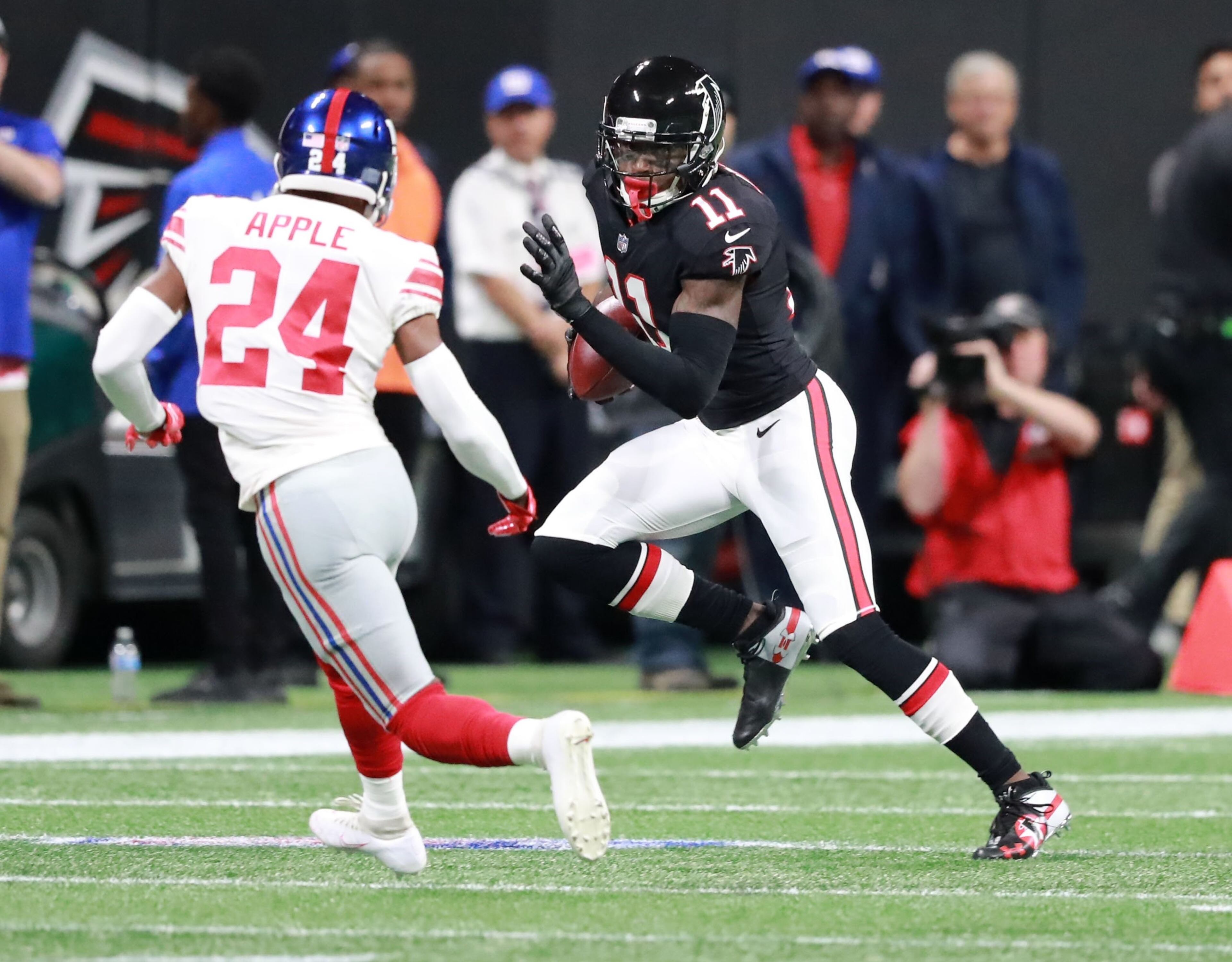 10/22/18 - Atlanta - Atlanta Falcons wide receiver Julio Jones (11) runs for a first down on the opening drive of the Falcons agains defender New York Giants cornerback Eli Apple (24). The Atlanta Falcons played the New York Giants in an NFL football game Monday, October 22, 2018, at Mercedes-Benz Stadium in Atlanta, GA. CURTIS COMPTON / CCOMPTON@AJC.COM
