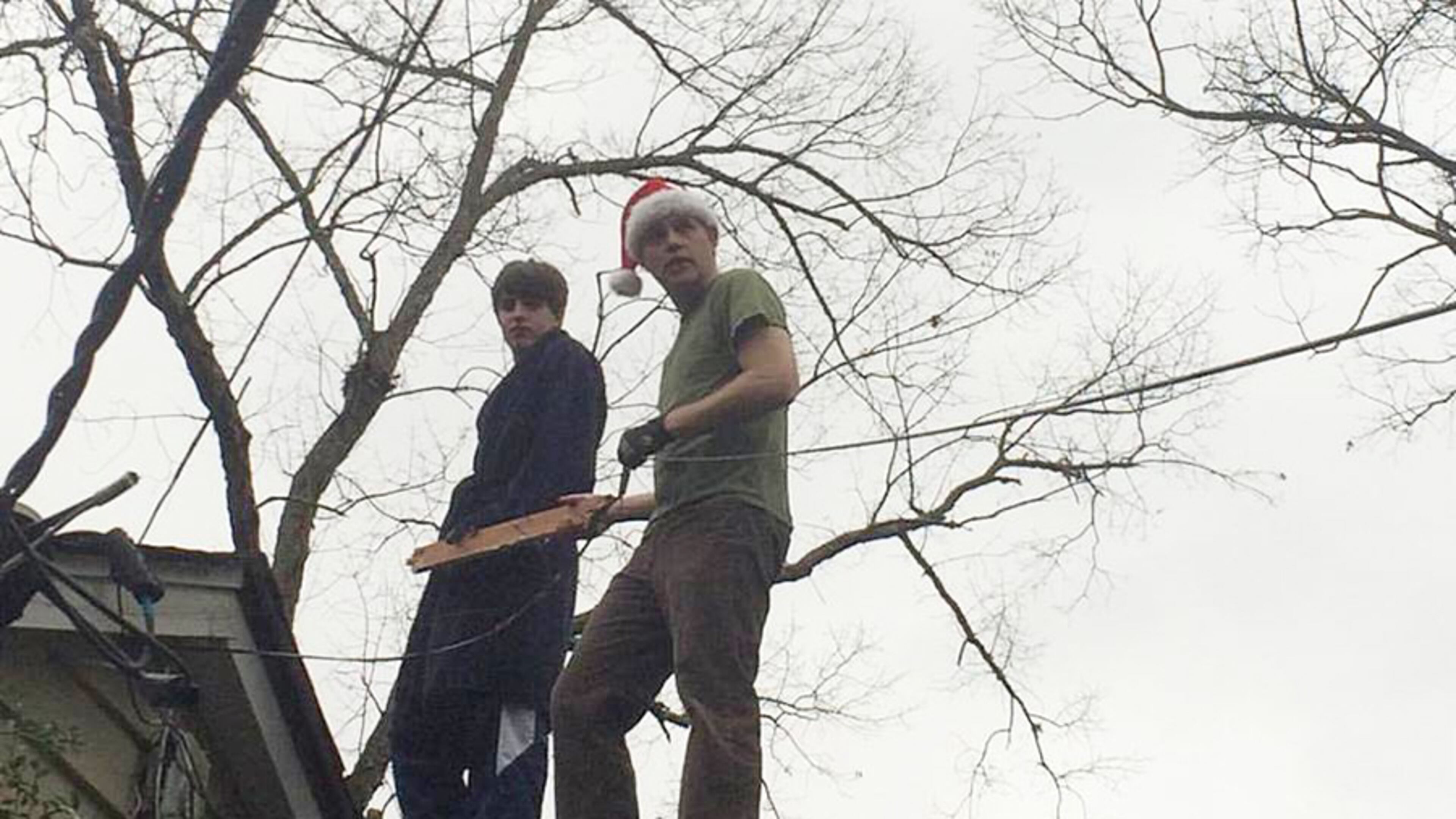 Thornton Kennedy II (in the Santa hat) of Atlanta and his son Thornton spent Christmas Day up on the rooftop ... addressing wires tossed about during Christmas Eve storms.