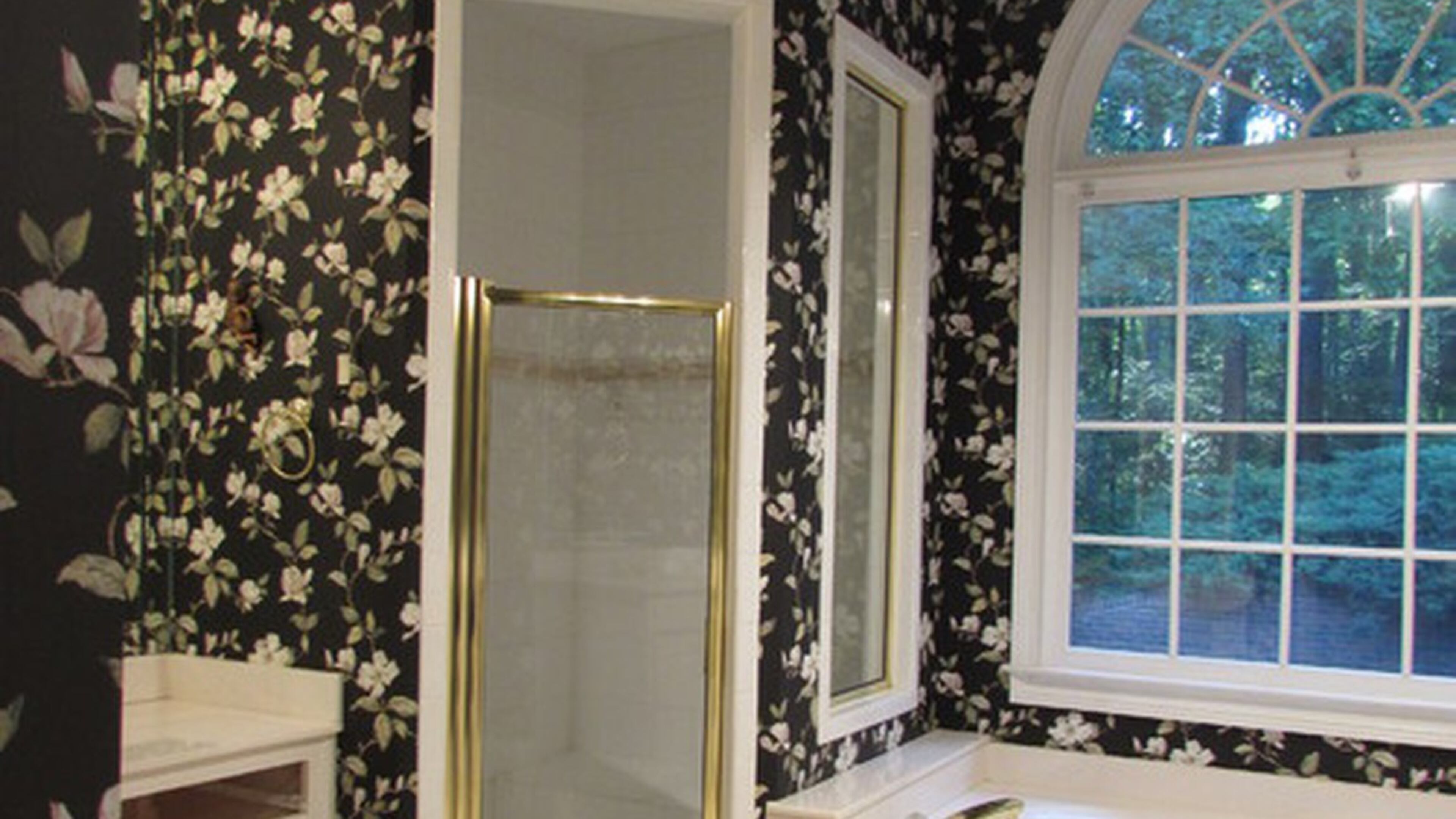 Magnolia wallpaper dated and darkened the bathroom of a Milton home before a renovation. PHOTO CREDIT: Beth Johnson