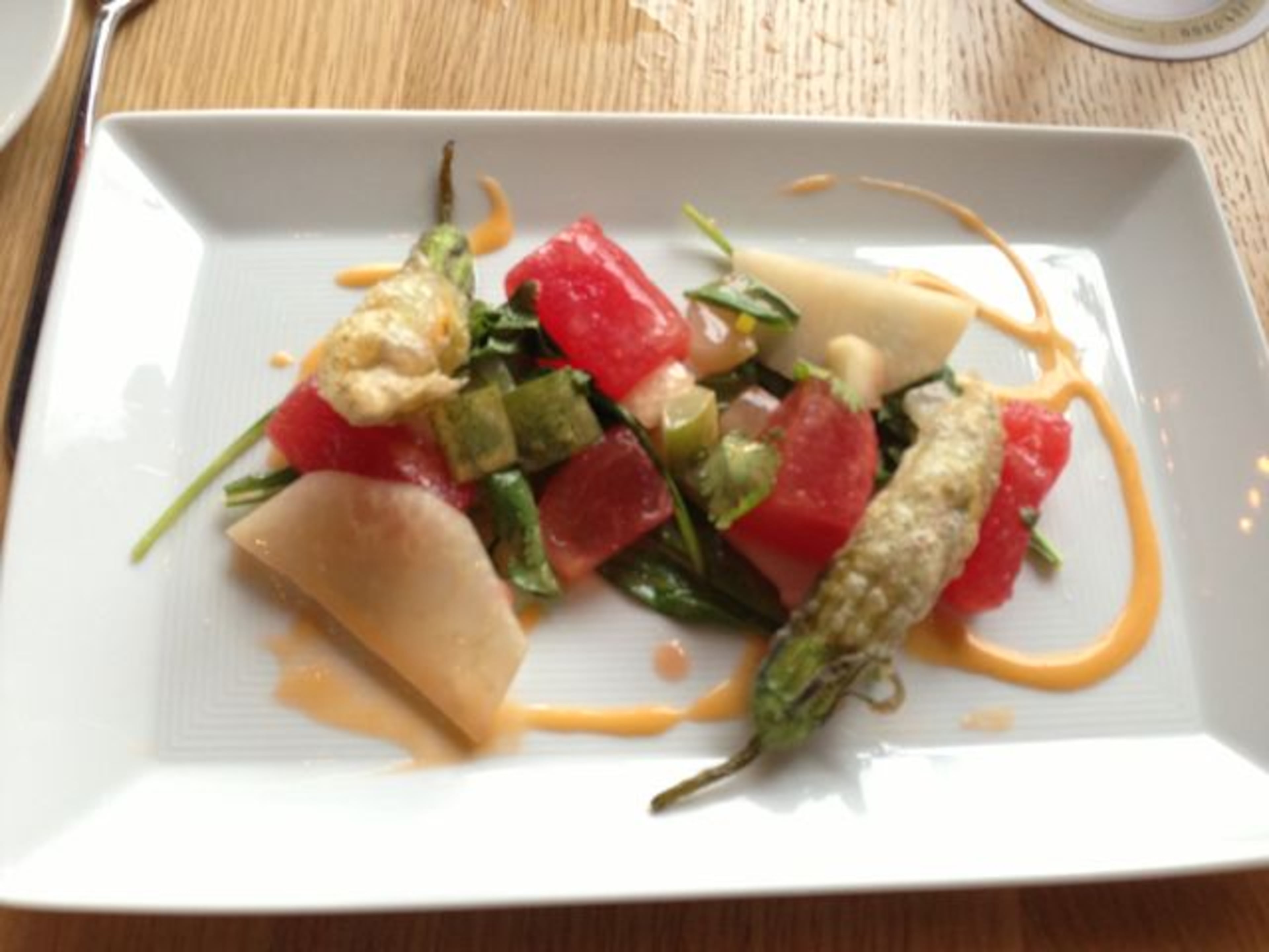 "Watermelon salad with pickled watermelon rind, cukes and ricotta-stuffed squash blossoms is a lively dance of fresh, rich and tangy flavors. "