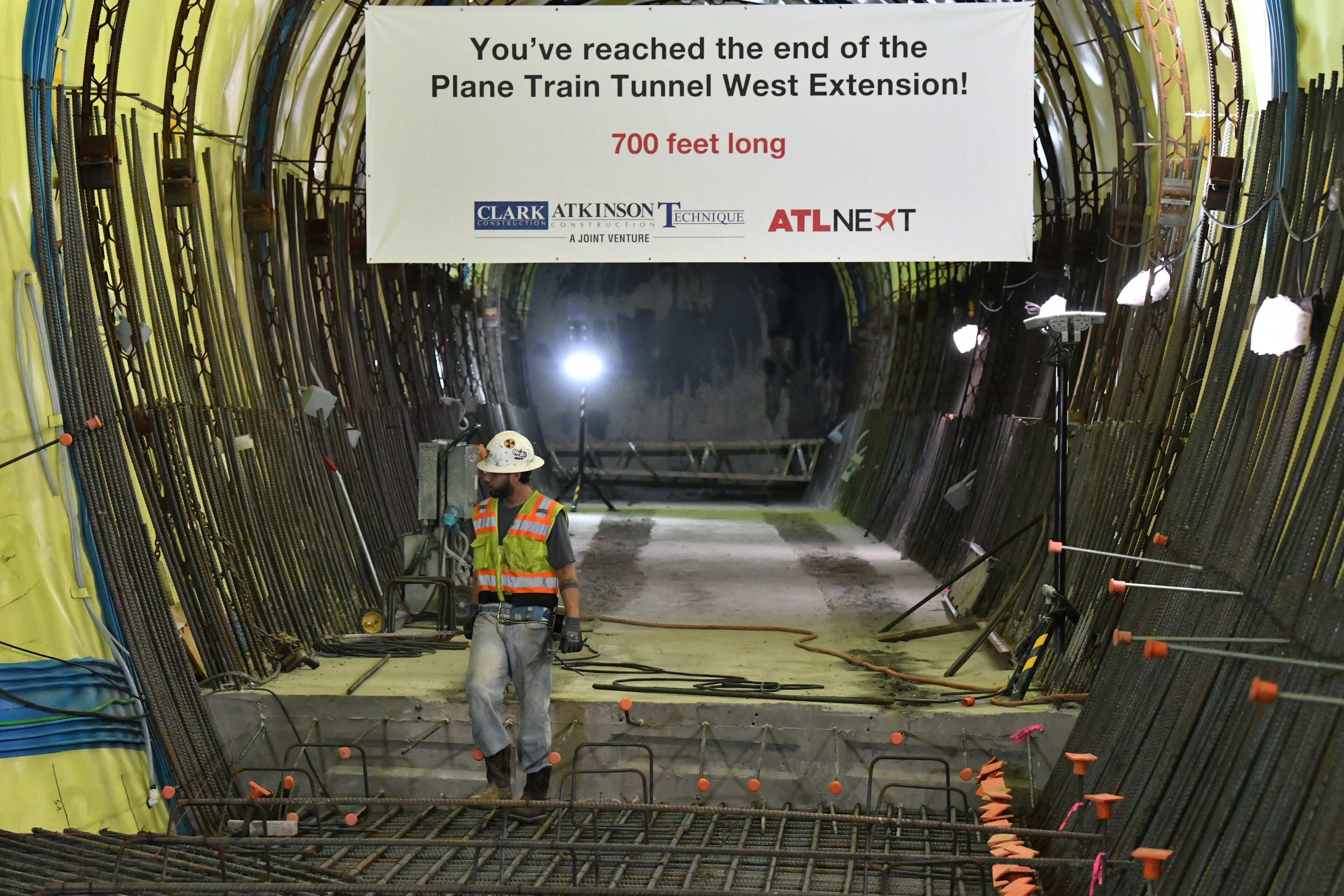 June 9, 2022 Atlanta - Construction crew work at a 700-foot-long tunnel under construction beneath Hartsfield-Jackson International . The Atlanta airport has for decades had a reputation in the aviation industry for having one of the most efficient layouts in the country, enabling passengers to quickly and easily connect between flights via parallel concourses linked by a single underground Plane Train line. (Hyosub Shin / Hyosub.Shin@ajc.com)