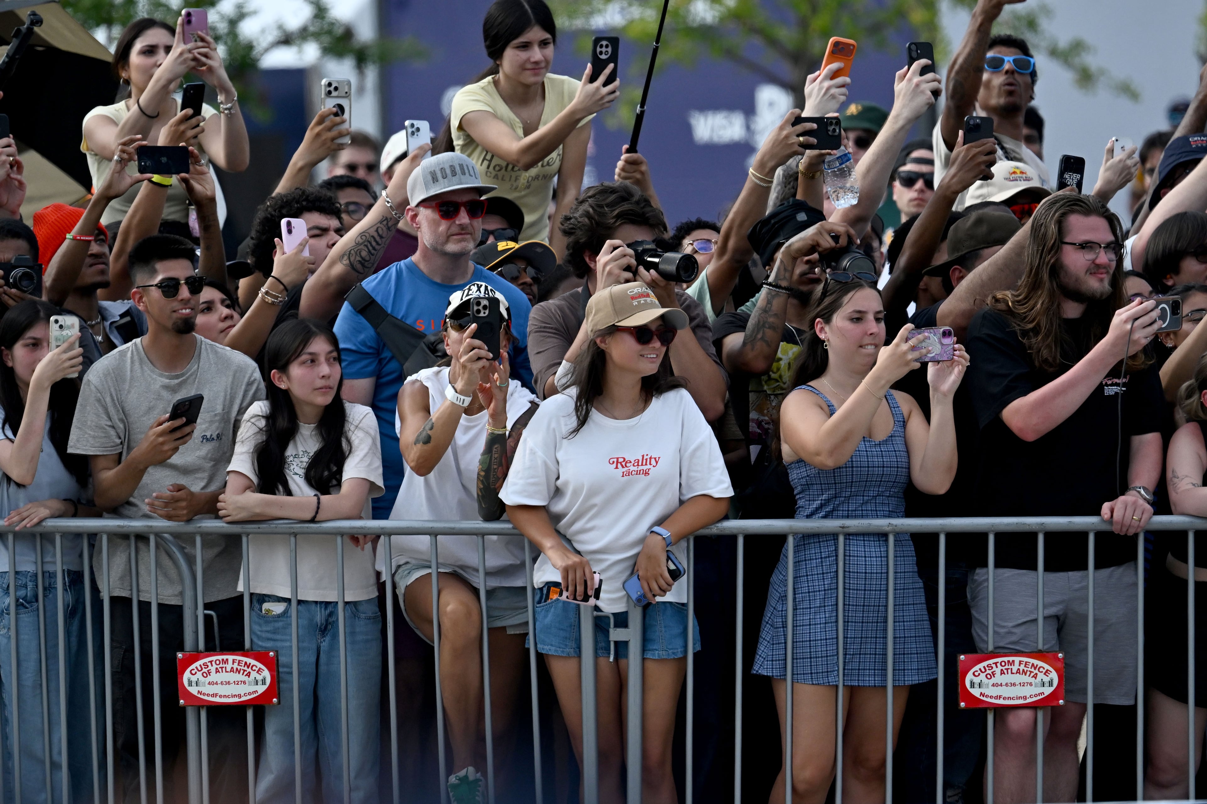 Spectators hold up their smartphones to capture a demonstration run on Hank Aaron Drive during the Red Bull Showrun Atlanta Presented by Ford Racing on Saturday, Aug. 1, 2026, in Atlanta. Atlanta city officials this week approved permits for the Red Bull Showrun that will allow the live motorsports demonstration event to go on as advertised along a roughly half-mile stretch of Hank Aaron Drive — a backup location after earlier plans to hold the event near Piedmont Park ran into opposition from Midtown residents. (Hyosub Shin/AJC)