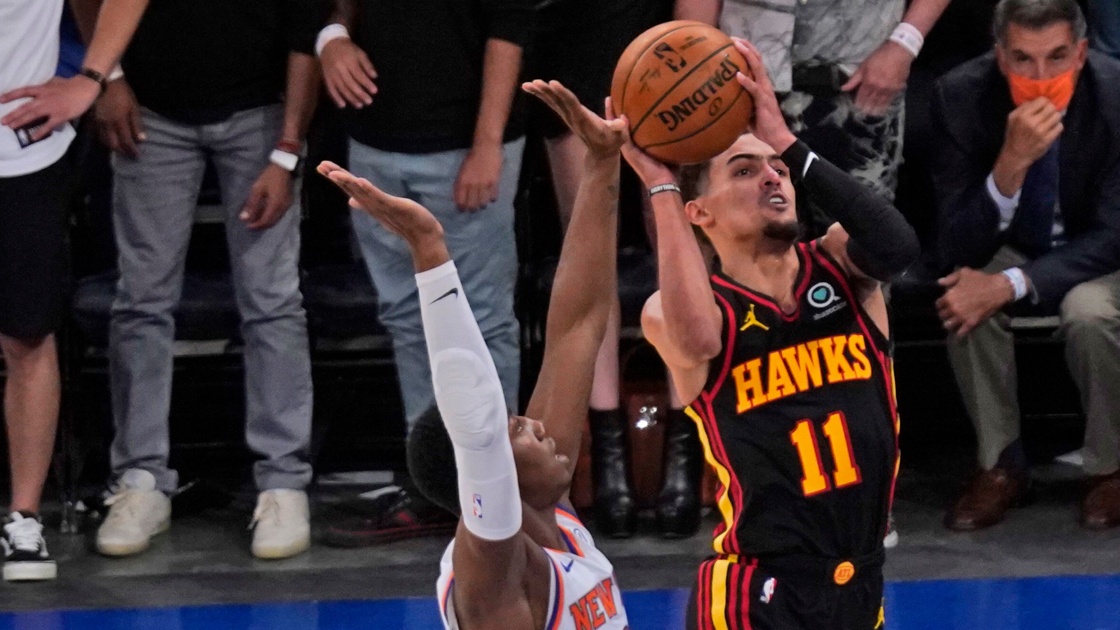 New York Knicks' RJ Barrett (left) fouls Atlanta Hawks' Trae Young during the second half of Game 1 of first-round playoff series, Sunday, May 23, 2021, in New York. The Hawks won 107-105. (Seth Wenig/AP)