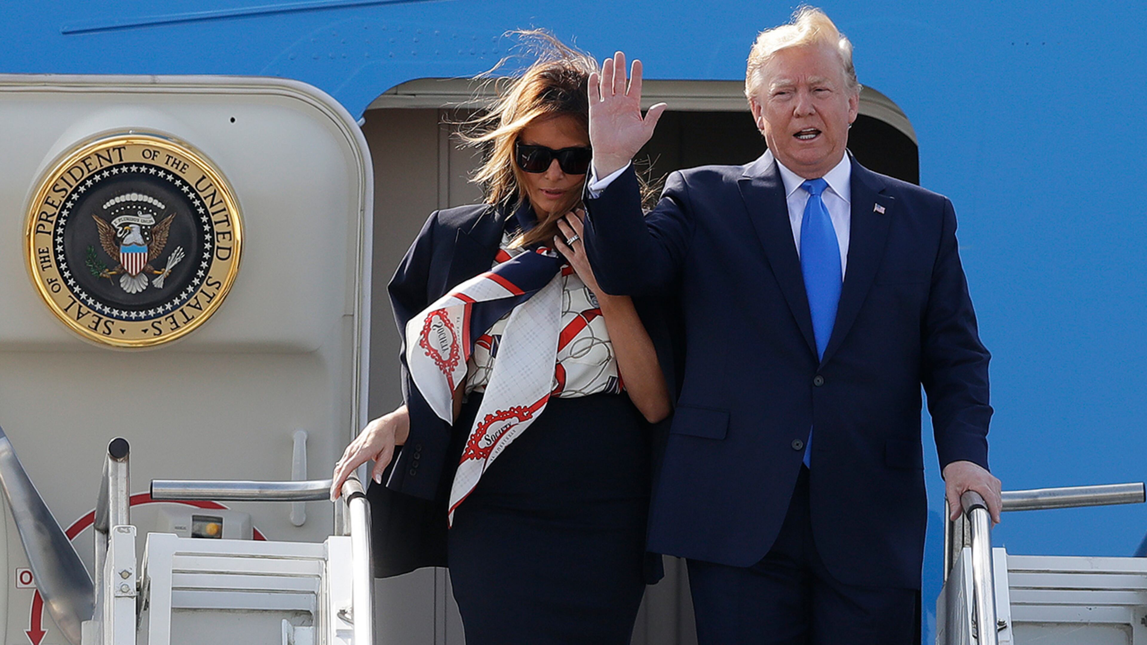 President Donald Trump waves and he and first lady Melania Trump arrive at Stansted Airport in England, Monday, June 3, 2019 at the start of a three day state visit to Britain. (AP Photo/Kirsty Wigglesworth)