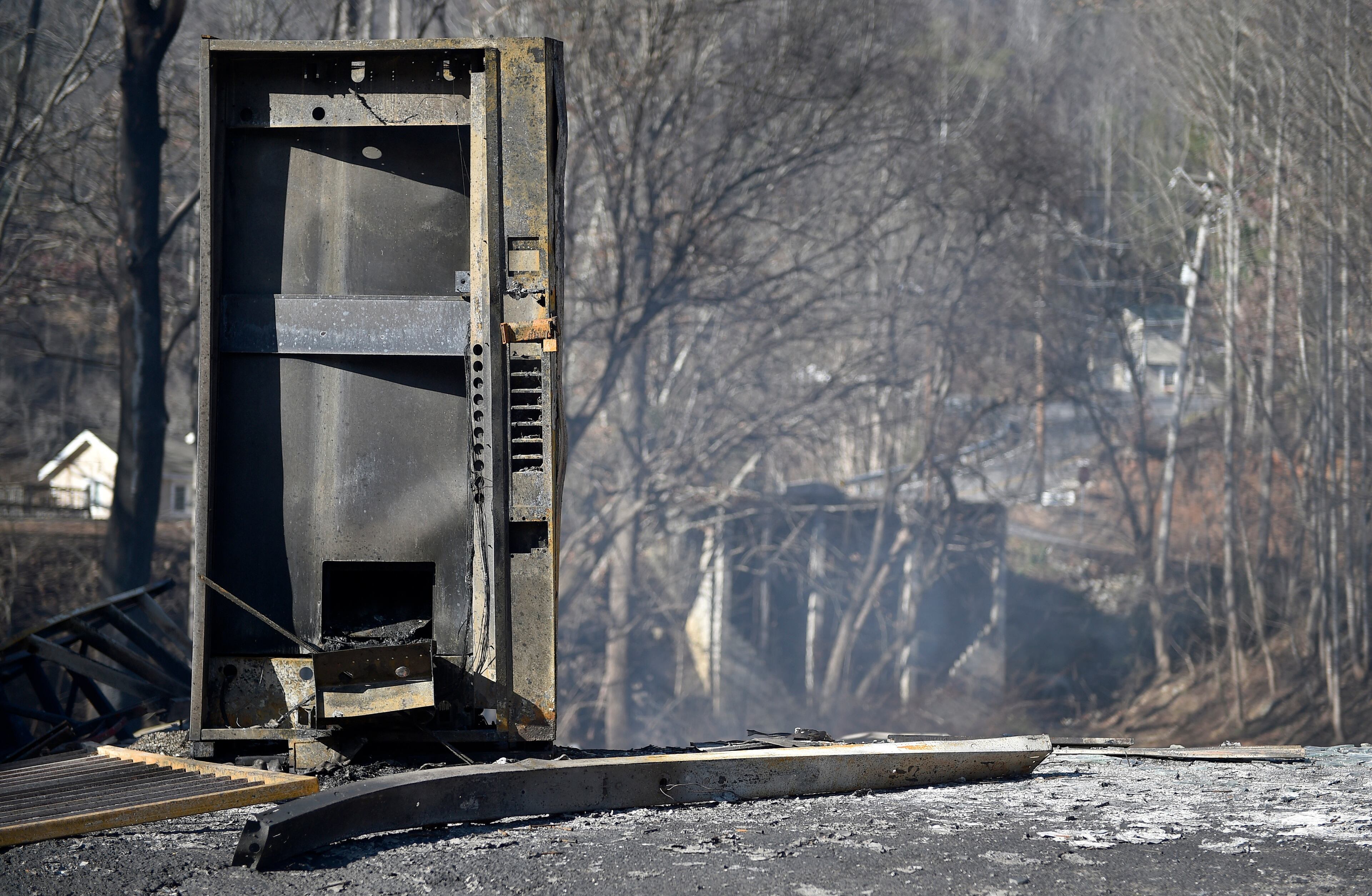 A burned vending machine rests outside a destroyed building, Tuesday, Nov. 29, 2016, in Gatlinburg, Tenn., after a wildfire swept through the area Monday. (Andrew Nelles/The Tennessean via AP)