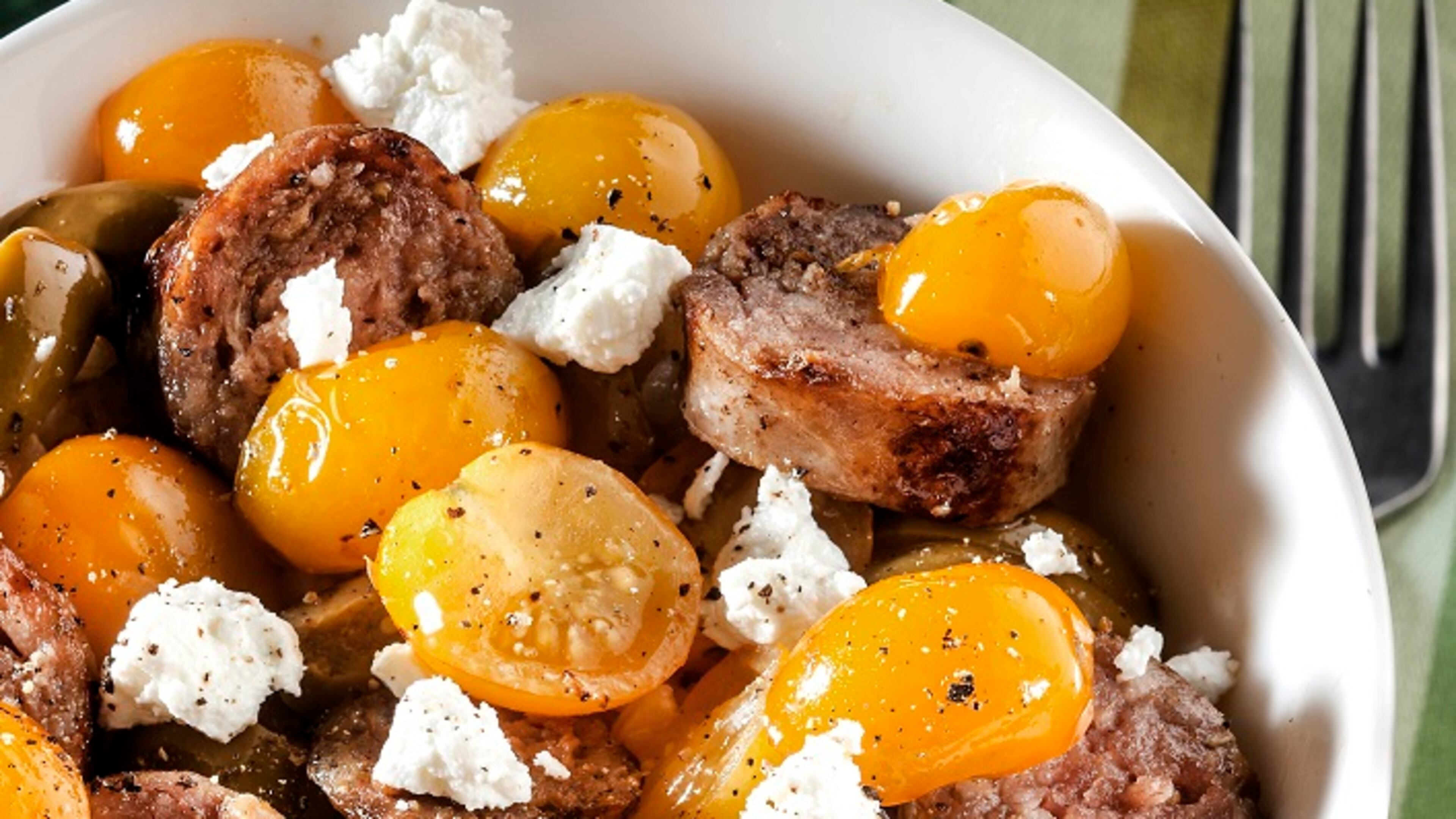 Sweet-as-candy Sun Gold tomatoes offer contrast to the richness of Italian sausage and goat cheese. (Bill Hogan/Chicago Tribune/TNS)