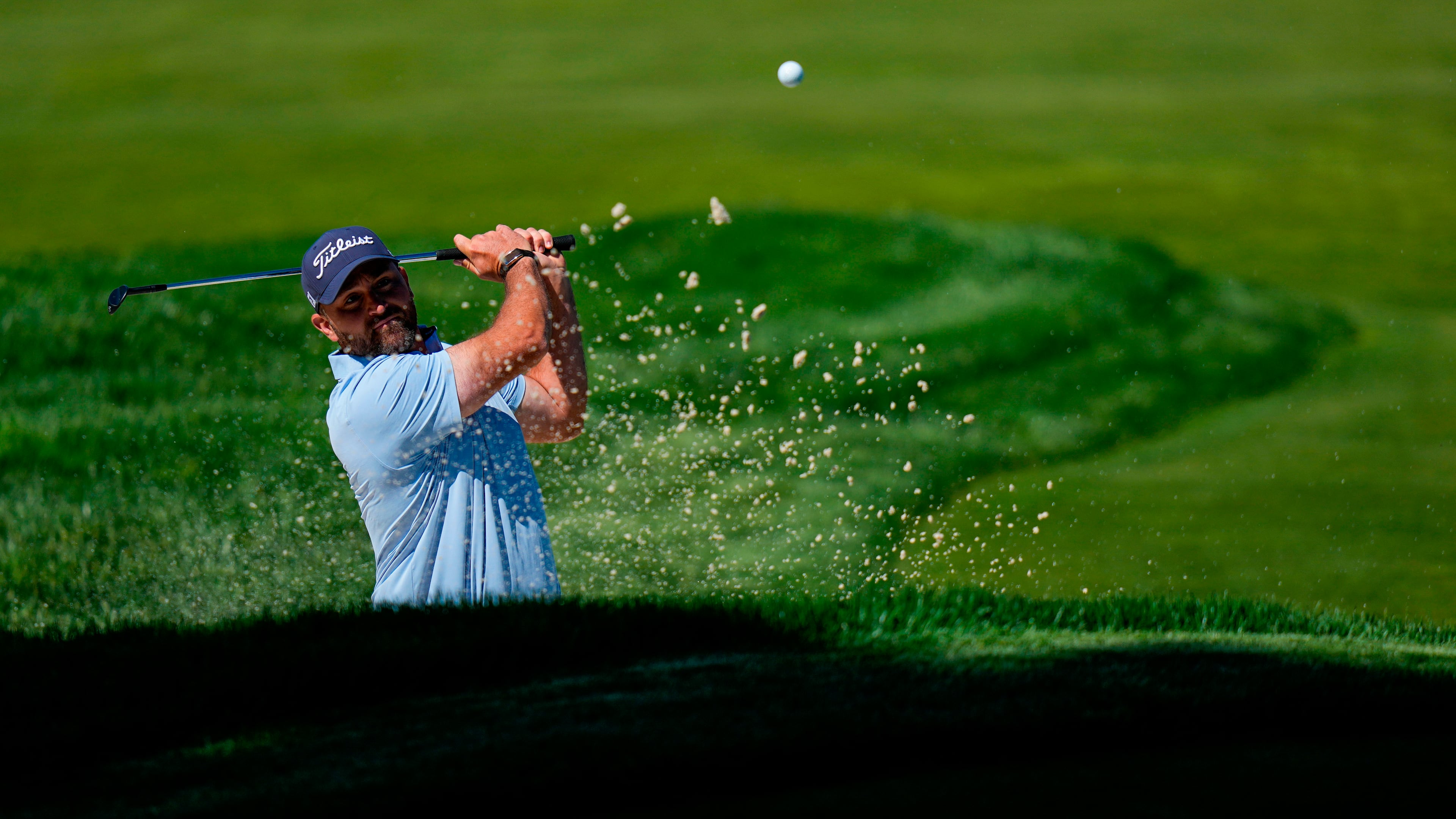 Braden Shattuck hits from the bunker during a PGA Championship golf tournament practice round at Aronimink Golf Club, Tuesday, May 12, 2026, in Newtown Square, PA. (AP Photo/Frank Franklin II)