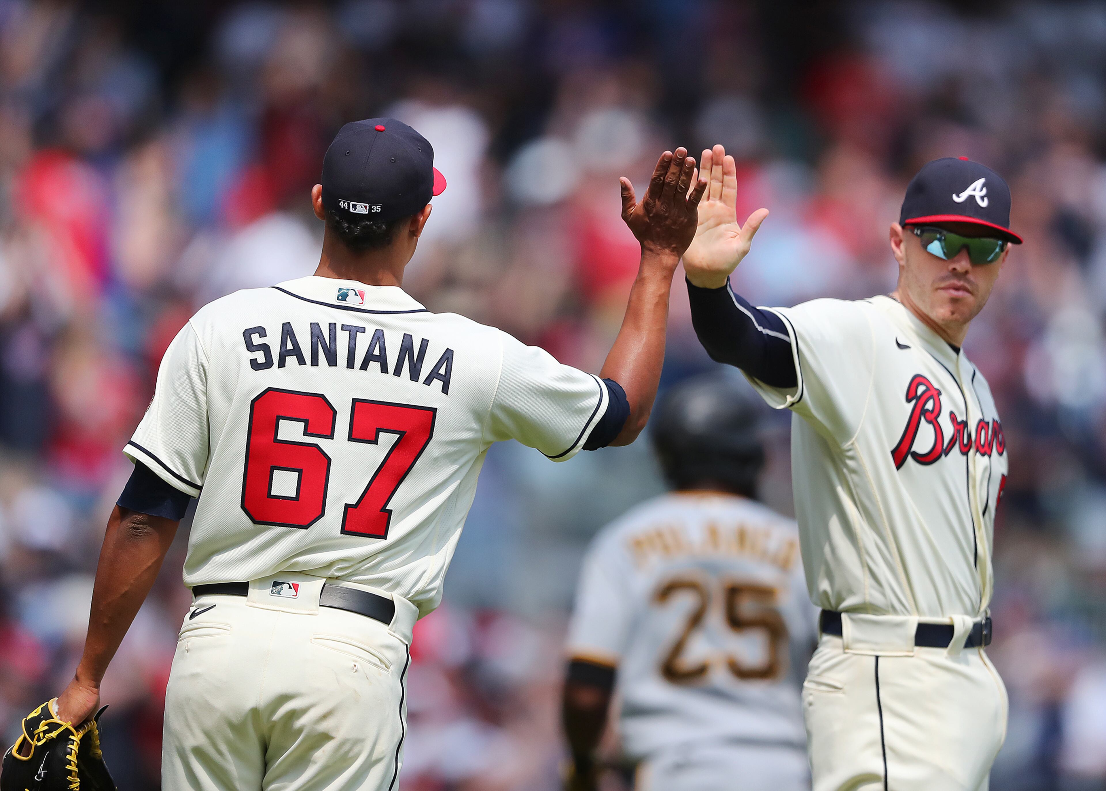 Braves first baseman Freddie Freeman gives pitcher Edgar Santana a high-five after he closed out the Pittsburgh Pirates in the ninth inning of a 7-1 victory Sunday, May 23, 2021, at Truist Park in Atlanta. (Curtis Compton / Curtis.Compton@ajc.com)