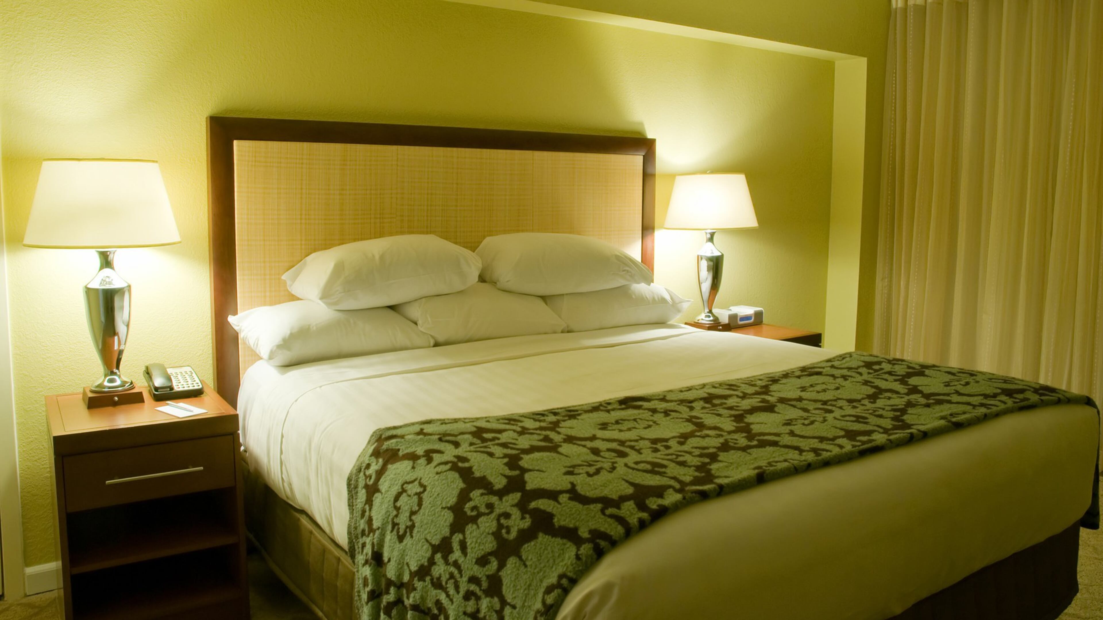 To get the look the look of a luxury hotel suite at home, pile on rich linens, memorable task lighting and standout patterns and textures. (Dreamstime)