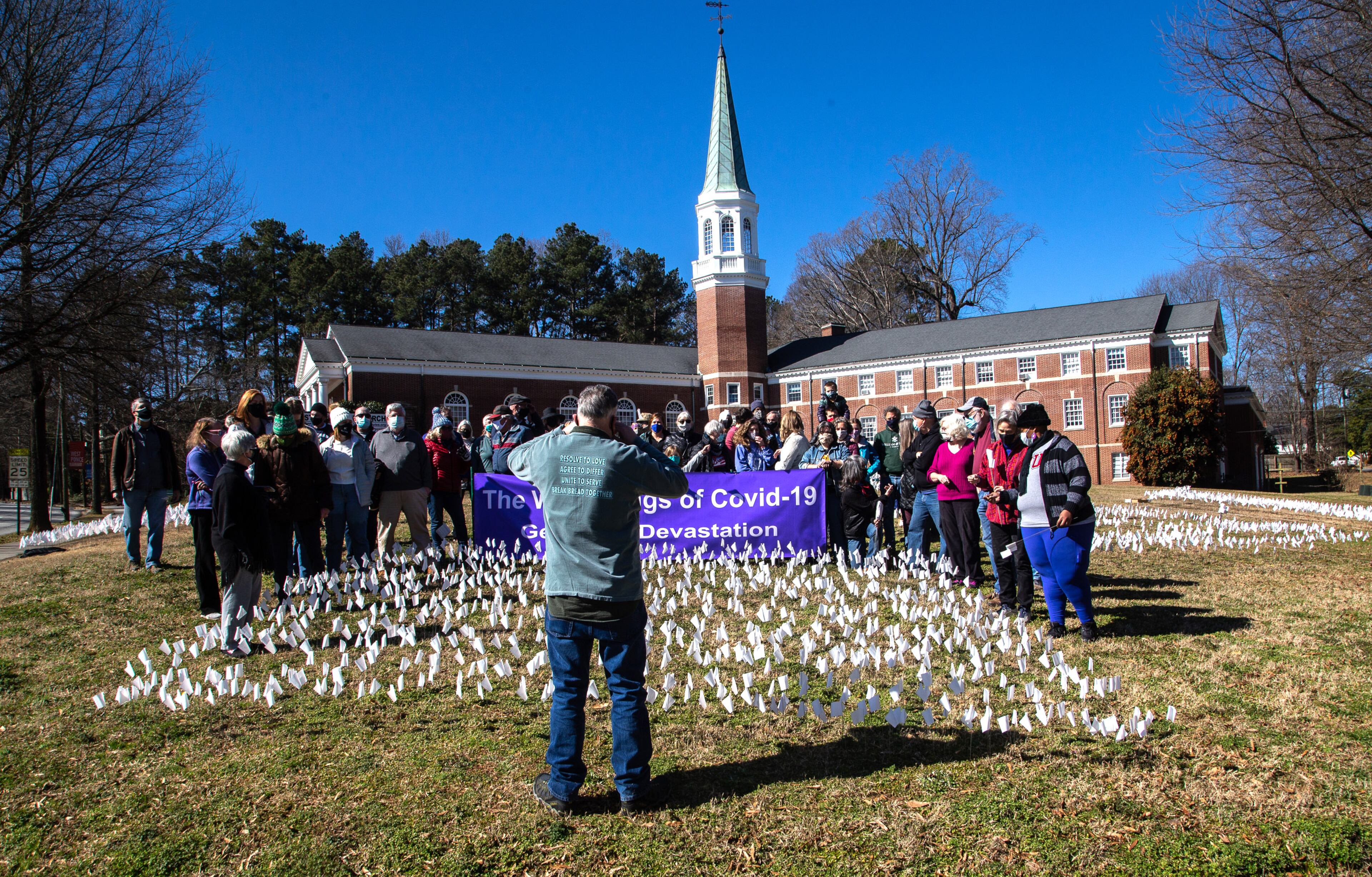 Volunteers line up for a group shot after placing 15,000 flags on the lawn of First Christian Church of Decatur on Saturday, February 20, 2021. The flags represent the number of COVID-19 deaths in Georgia, and the effort aims to raise awareness about the toll of the coronavirus. (Photo: Steve Schaefer for The Atlanta Journal-Constitution)