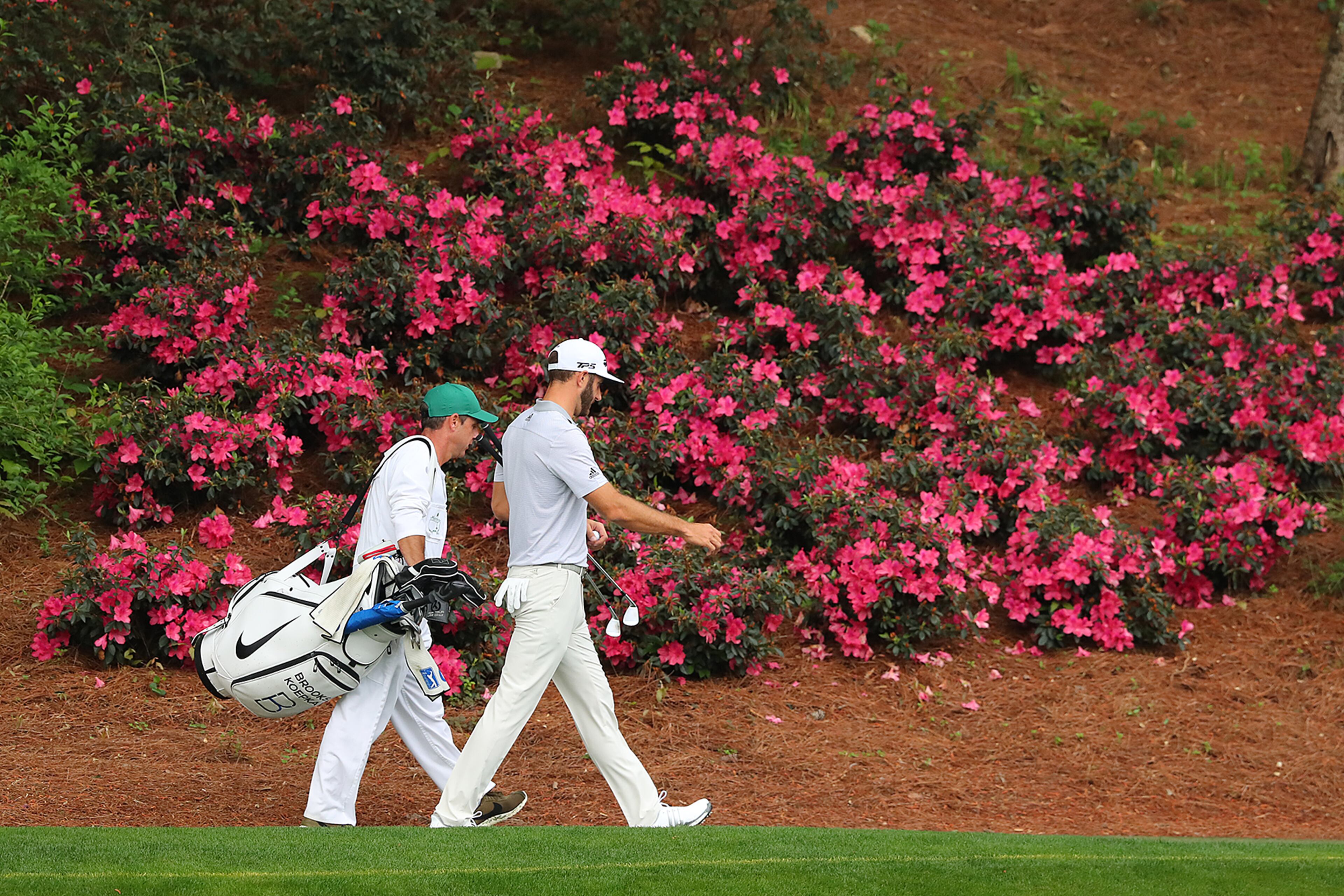 April 5, 2017, Augusta: Dustin Johnson and his caddie Austin Johnson, his brother, walk to the 12th green during his practice round for the Masters before play was suspended because of the weather at Augusta National Golf Club on Wednesday, April 5, 2017, in Augusta. Curtis Compton/ccompton@ajc.com