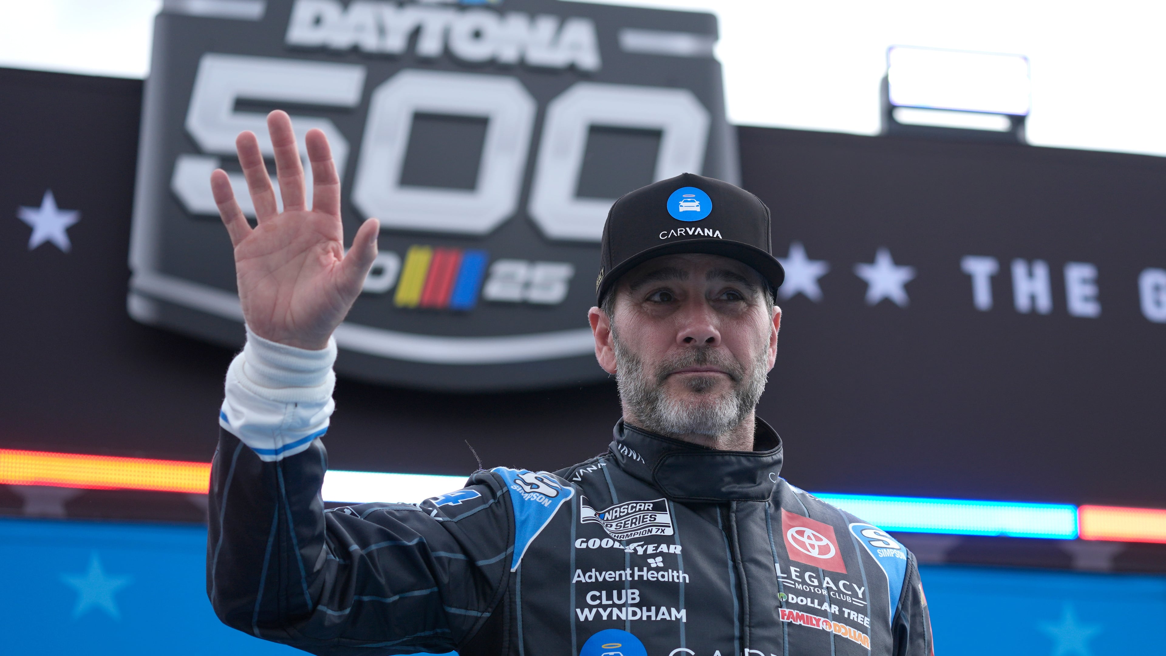 FILE - Jimmie Johnson waves during driver introductions before the NASCAR Daytona 500 auto race at Daytona International Speedway, Feb. 16, 2025, in Daytona Beach, Fla. (AP Photo/John Raoux, File)