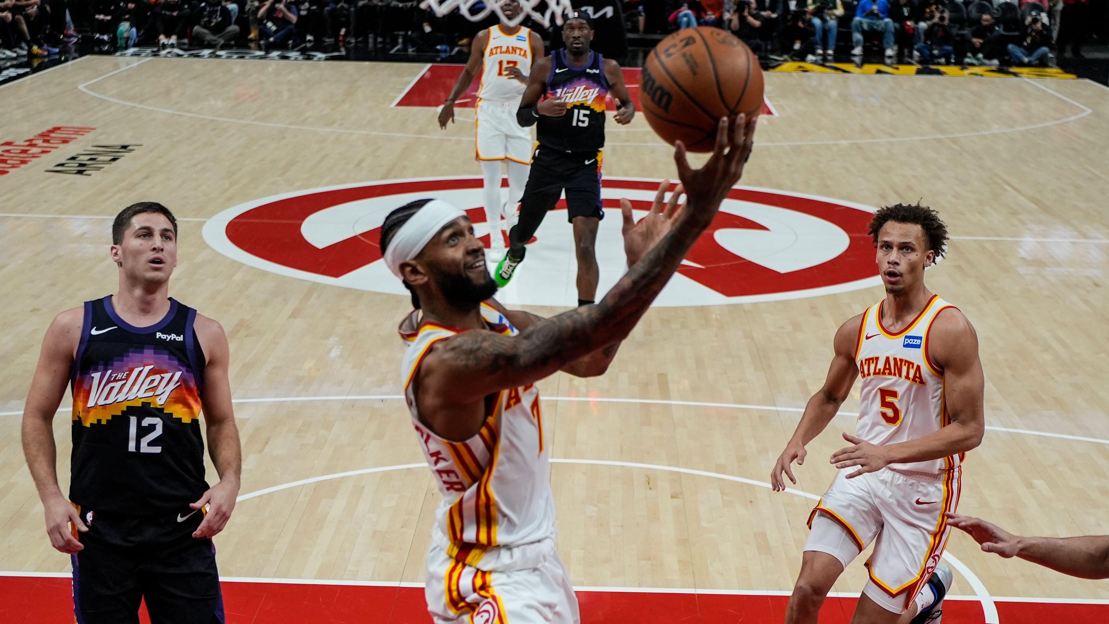 Hawks guard Nickeil Alexander-Walker (center) shoots during second half against the Suns on Friday, Jan. 23, 2026, in Atlanta. The Hawks won 110-103 for their second straight victory. (Mike Stewart/AP)