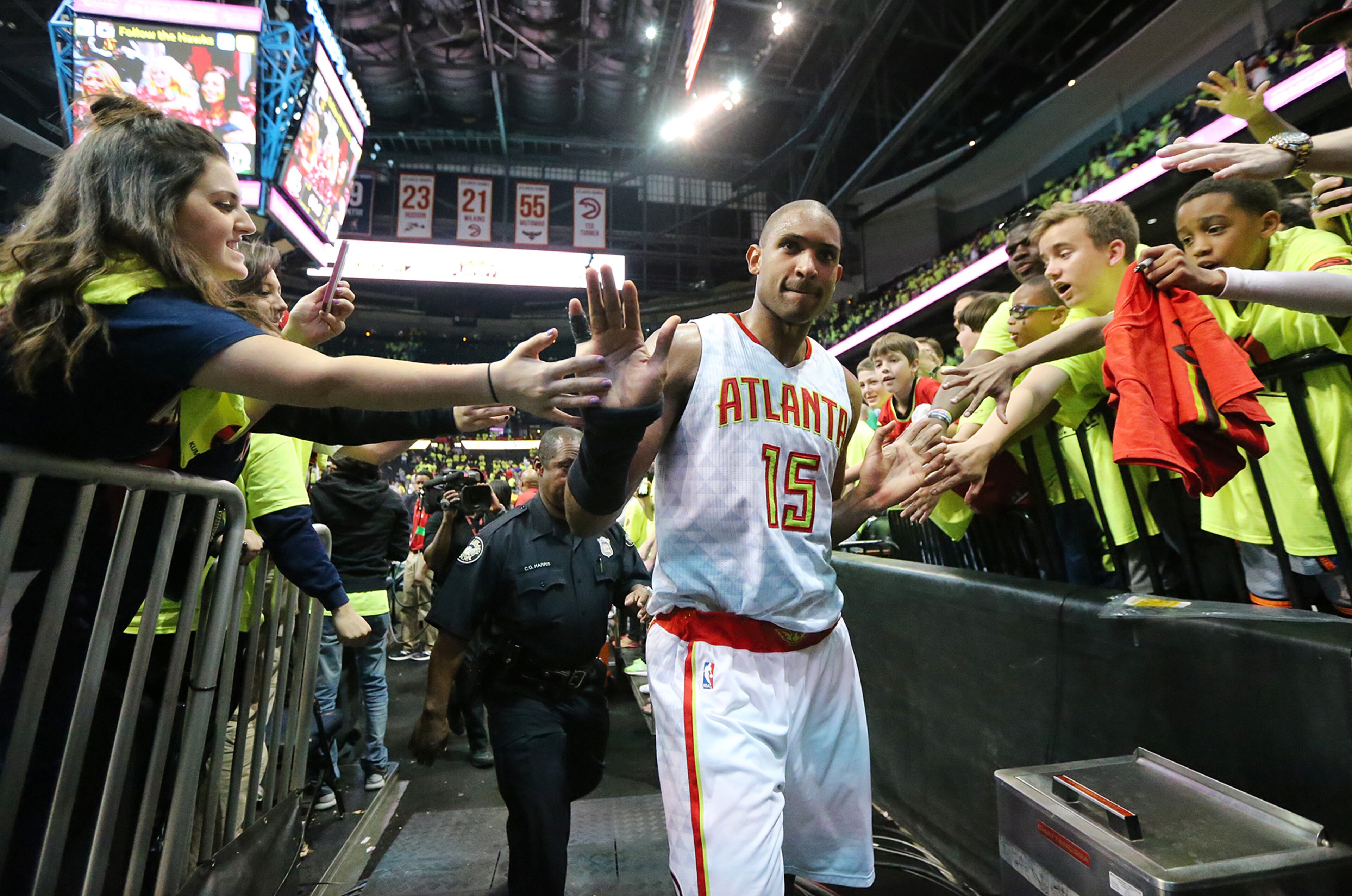 **** POSSIBLE VISUAL LEDE **** 041616 ATLANTA: Al Horford celebrates with fans as the Hawks beat the Celtics 102-101 in game one of their NBA Eastern Conference first round playoff game at Philips Arena on Saturday, April 16, 2016. Curtis Compton / ccompton@ajc.com