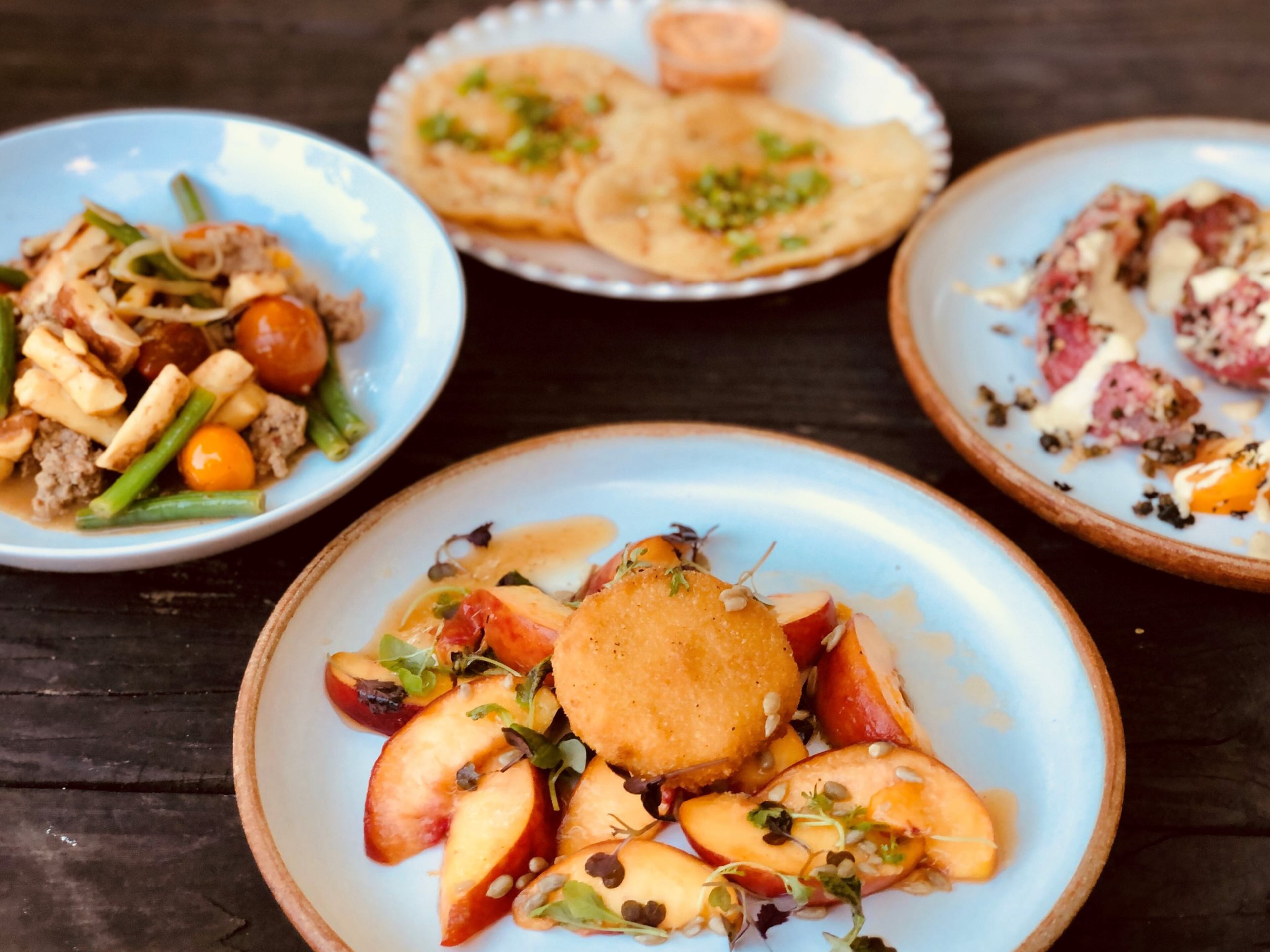 A peach salad with fried brie is a summer stunner at Banshee. In the background: Parisian gnocchi, fry bread and tomato Caesar. CONTRIBUTED BY WENDELL BROCK