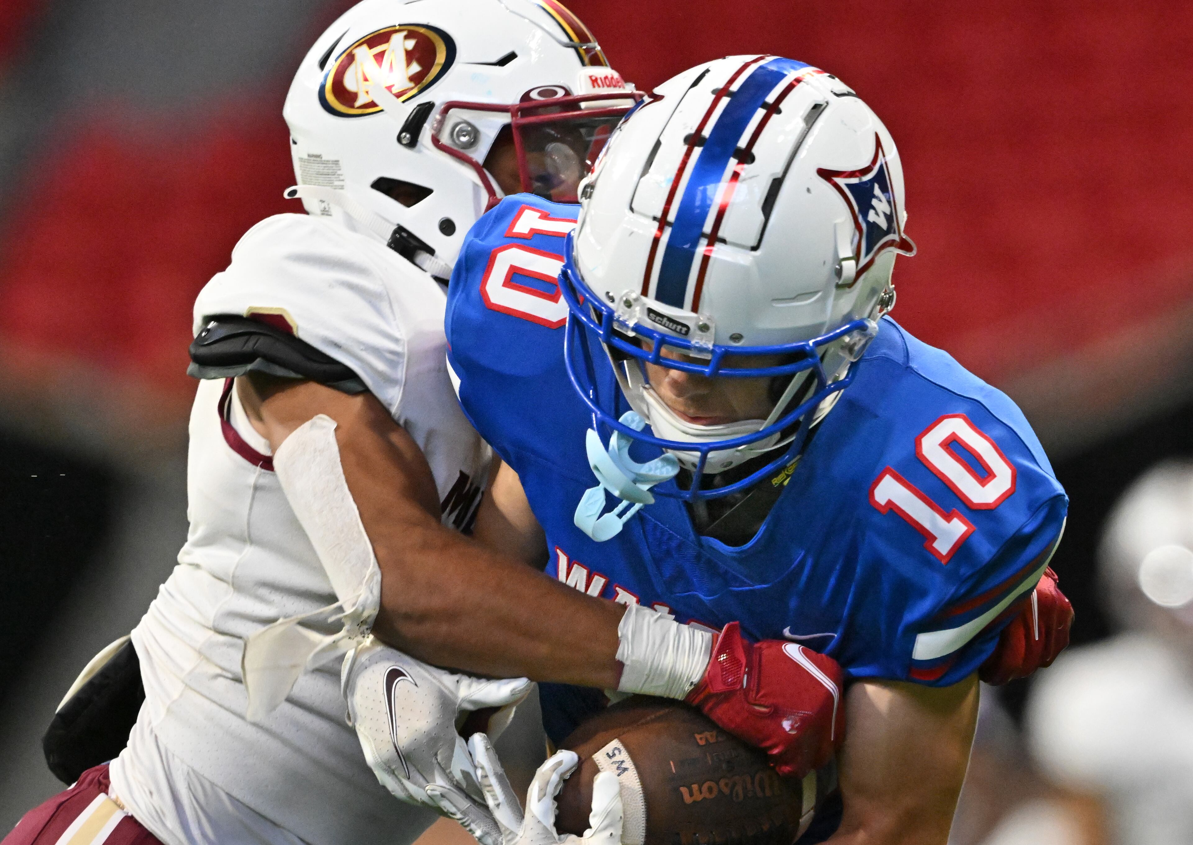 August 20 , 2022 Atlanta - Walton's Wyatt Sonderman (10) gets tackled by Mill Creek's Corey Rose (8) during the 2022 Corky Kell Classic at Mercedes Benz Stadium on Saturday, August 20, 2022. Mill Creek won 44-41 over Walton. (Hyosub Shin / Hyosub.Shin@ajc.com)