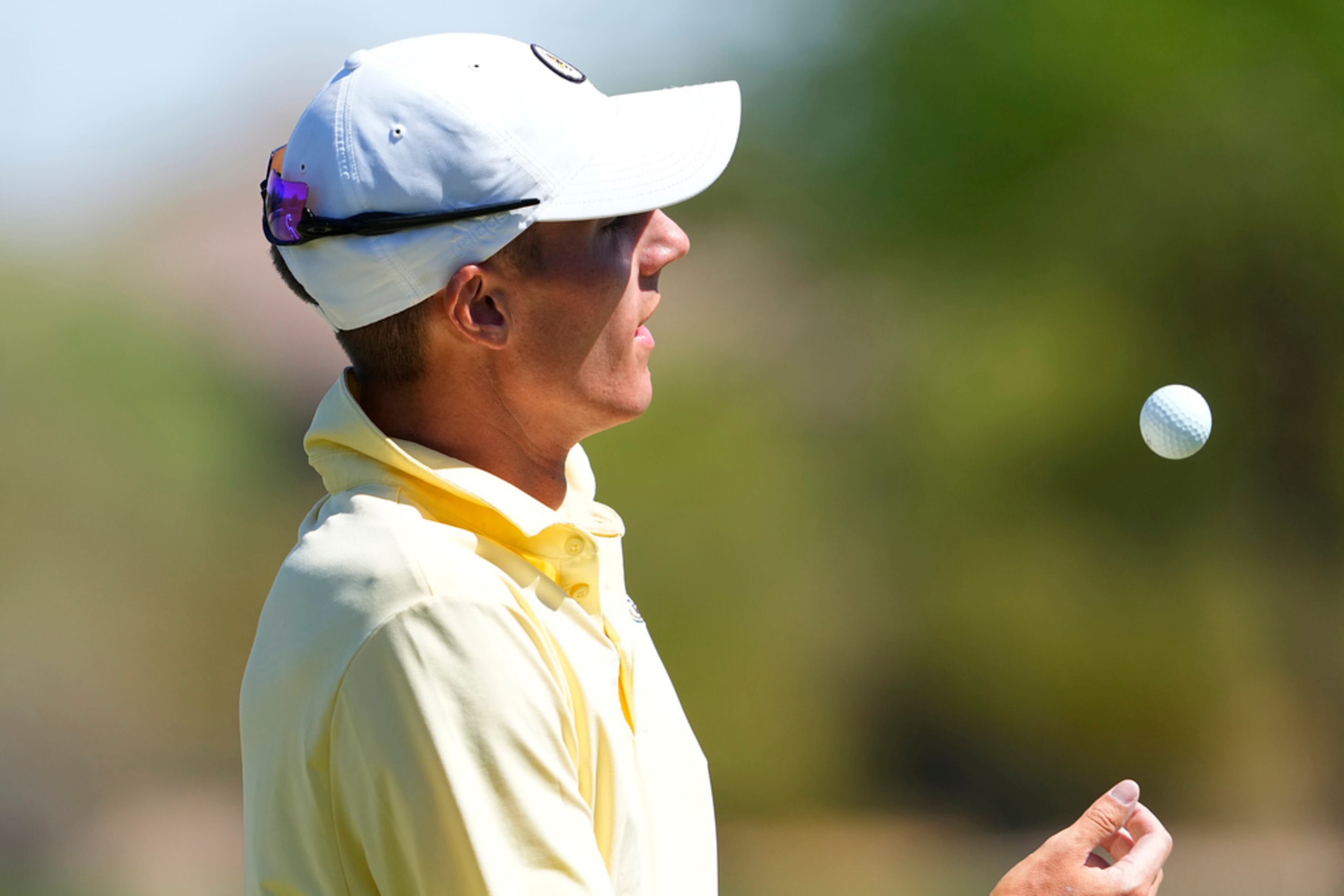 Georgia Tech golfer Ross Steelman flips his ball on the third green during the final round of the NCAA college men's match play golf championship, Wednesday, May 31, 2023, in Scottsdale, Ariz. (AP Photo/Matt York)