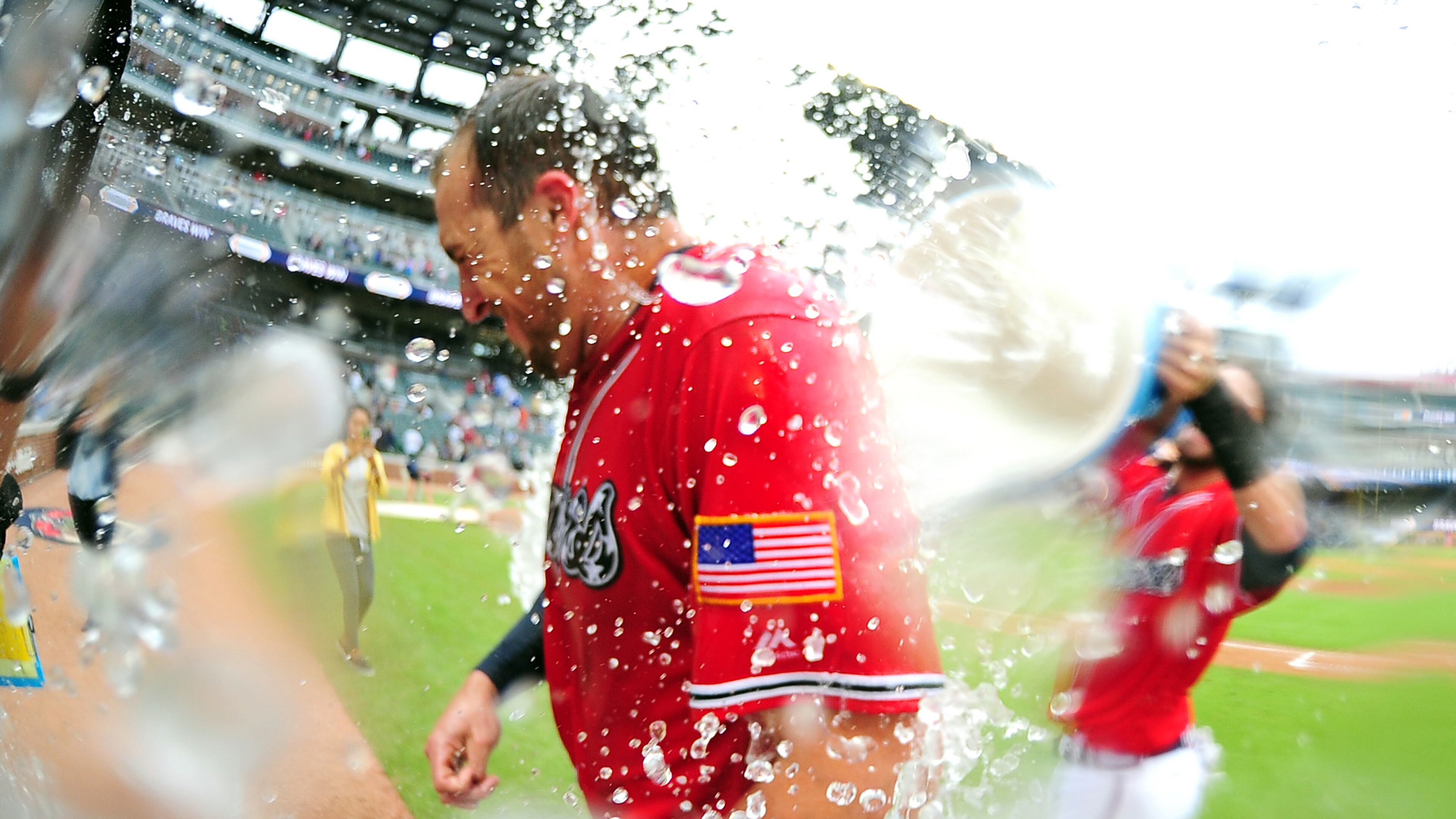Lane Adams of the Atlanta Braves is doused by Dansby Swanson after hitting a 10th inning two-run walkoff home run against the Miami Marlins at SunTrust Park on September 10, 2017 in Atlanta, Georgia. (Photo by Scott Cunningham/Getty Images)