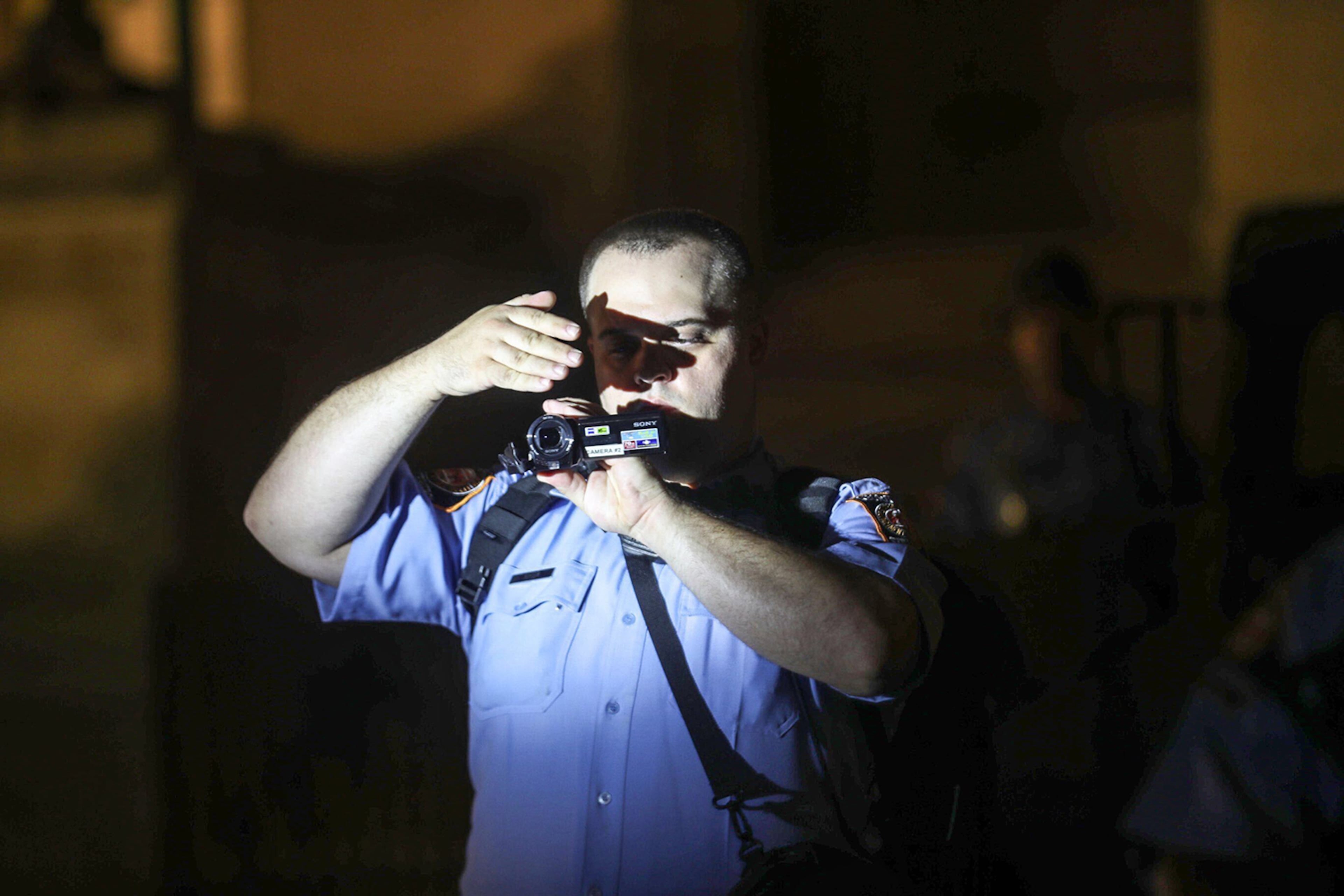 Demonstrators use a bright light Wednesday, Sept. 23, 2020, to attempt to stop a Georgia State Trooper from recording them as they chant and demonstrate outside of the Georgia State Capitol Building in Atlanta. (Alyssa Pointer / Alyssa Pointer@ajc.com)