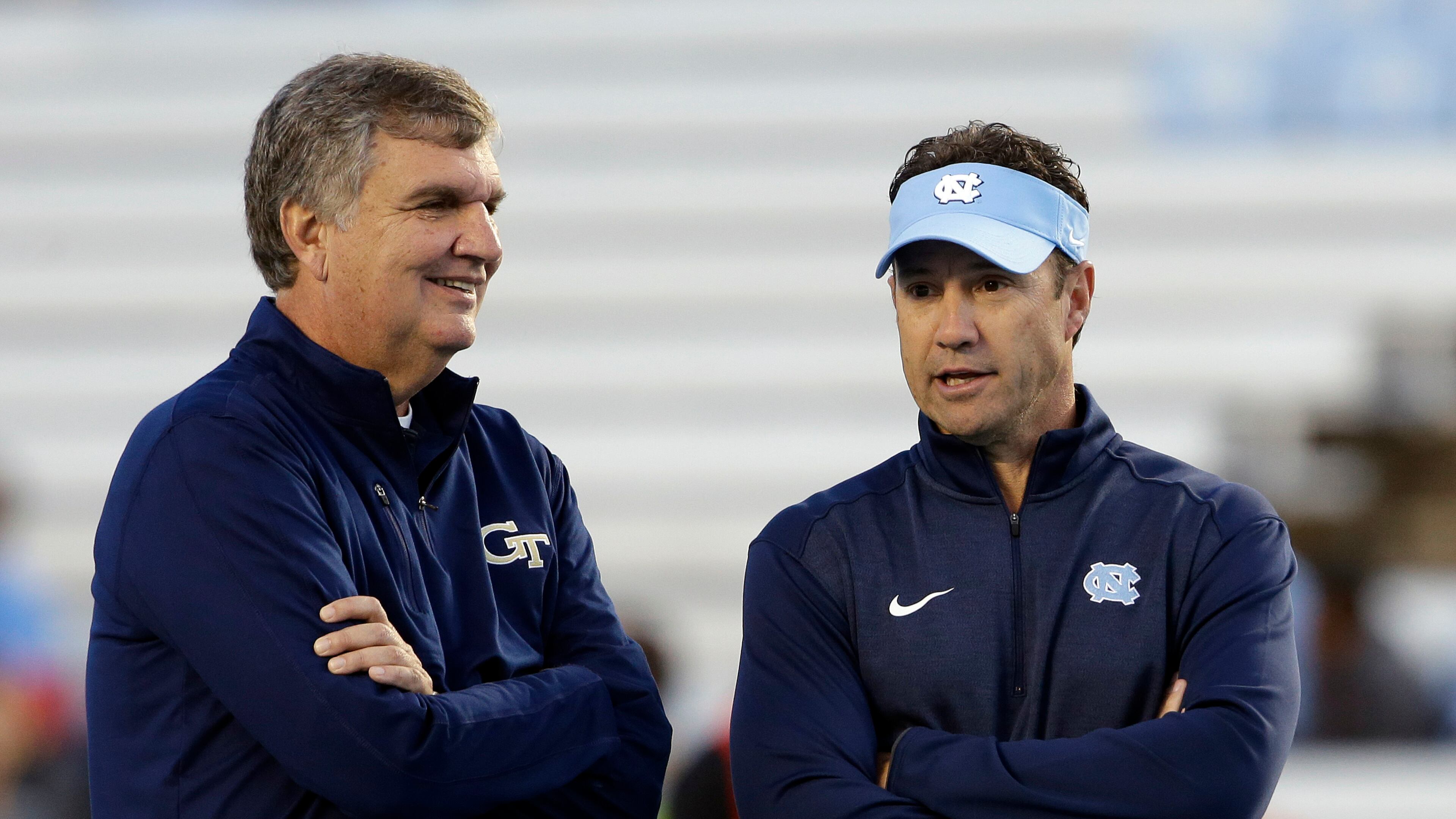Georgia Tech coach Paul Johnson, left, and North Carolina coach Larry Fedora talk prior to an NCAA college football game in Chapel Hill, N.C., Saturday, Oct. 18, 2014. (AP Photo/Gerry Broome)