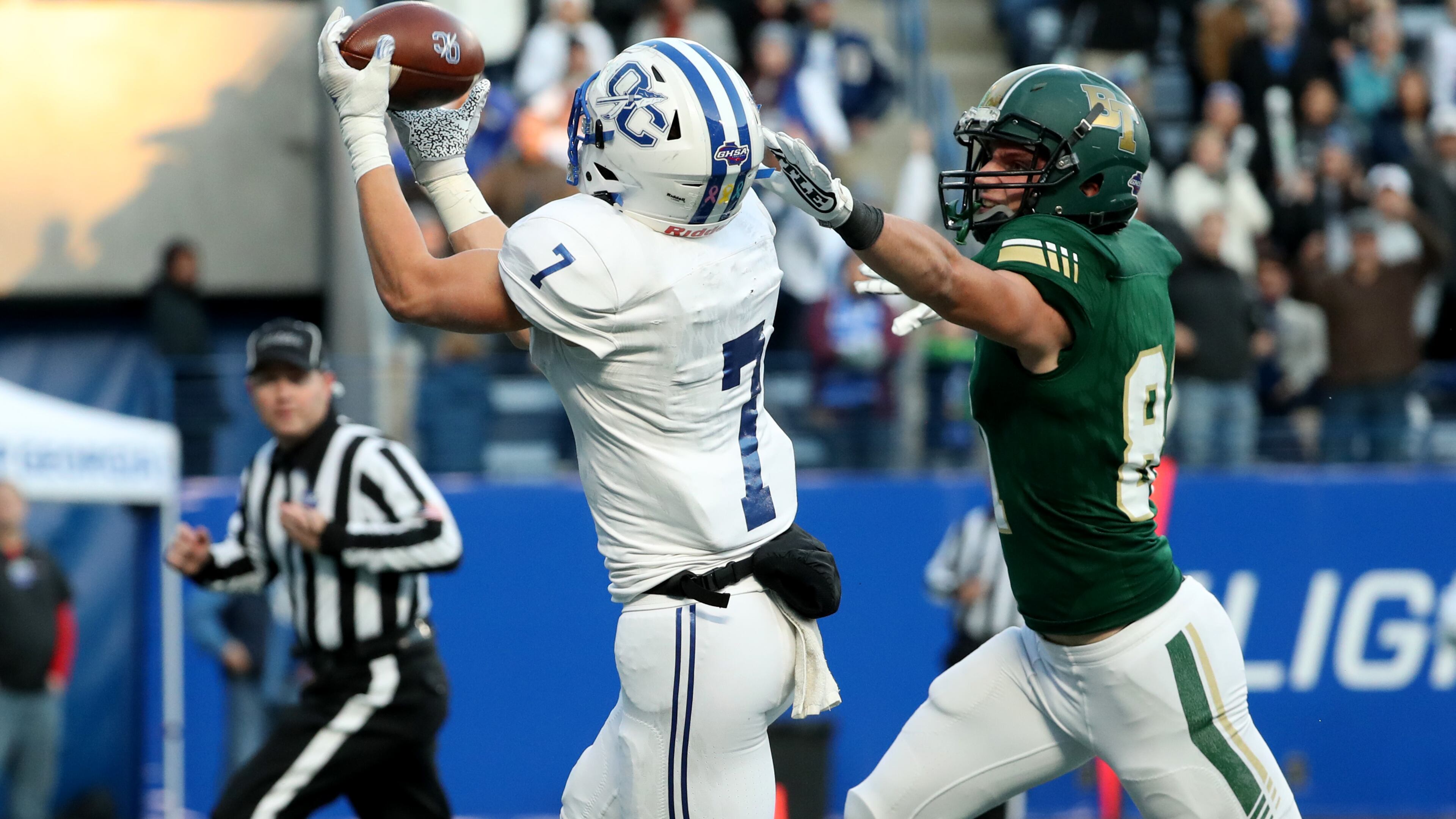Oconee County wide receiver West Weeks (7) makes a touchdown catch against Blessed Trinity defensive back James Bryant (81) during the first half of the 2019 Class 4A high school football state title at Georgia State Stadium Saturday, December 14, 2019 in Atlanta. (JASON GETZ/SPECIAL TO THE AJC)