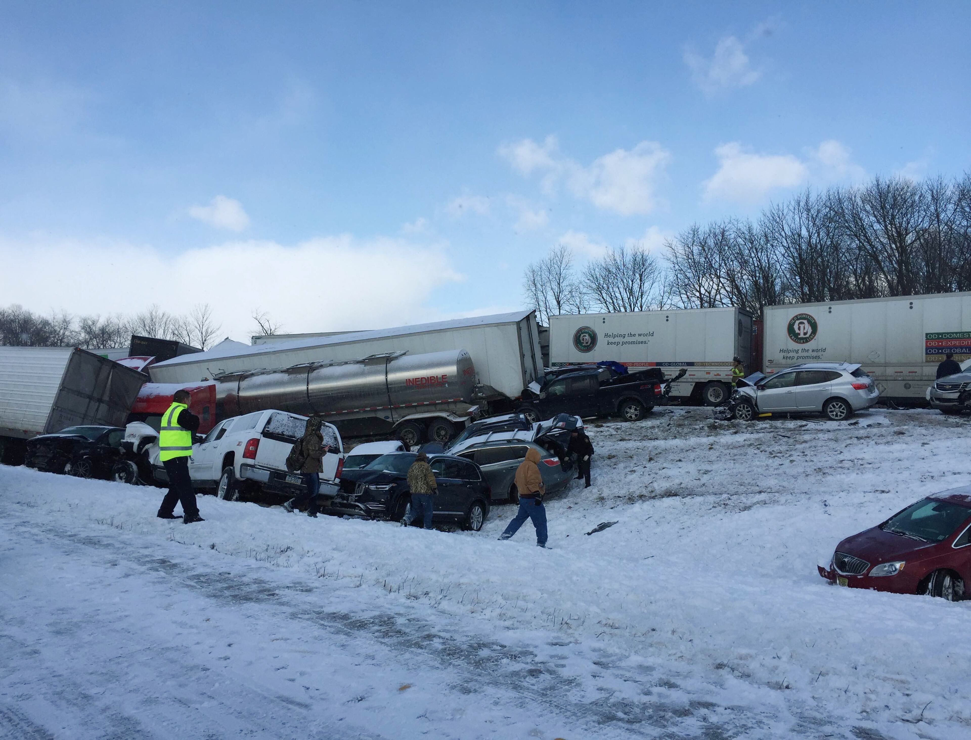 Vehicles pile up at the site of a fatal crash near Fredericksburg, Pa., Saturday, Feb. 13, 2016. The pileup left tractor-trailers, box trucks and cars tangled together across several lanes of traffic and into the snow-covered median. (Cooper Leslie via AP)