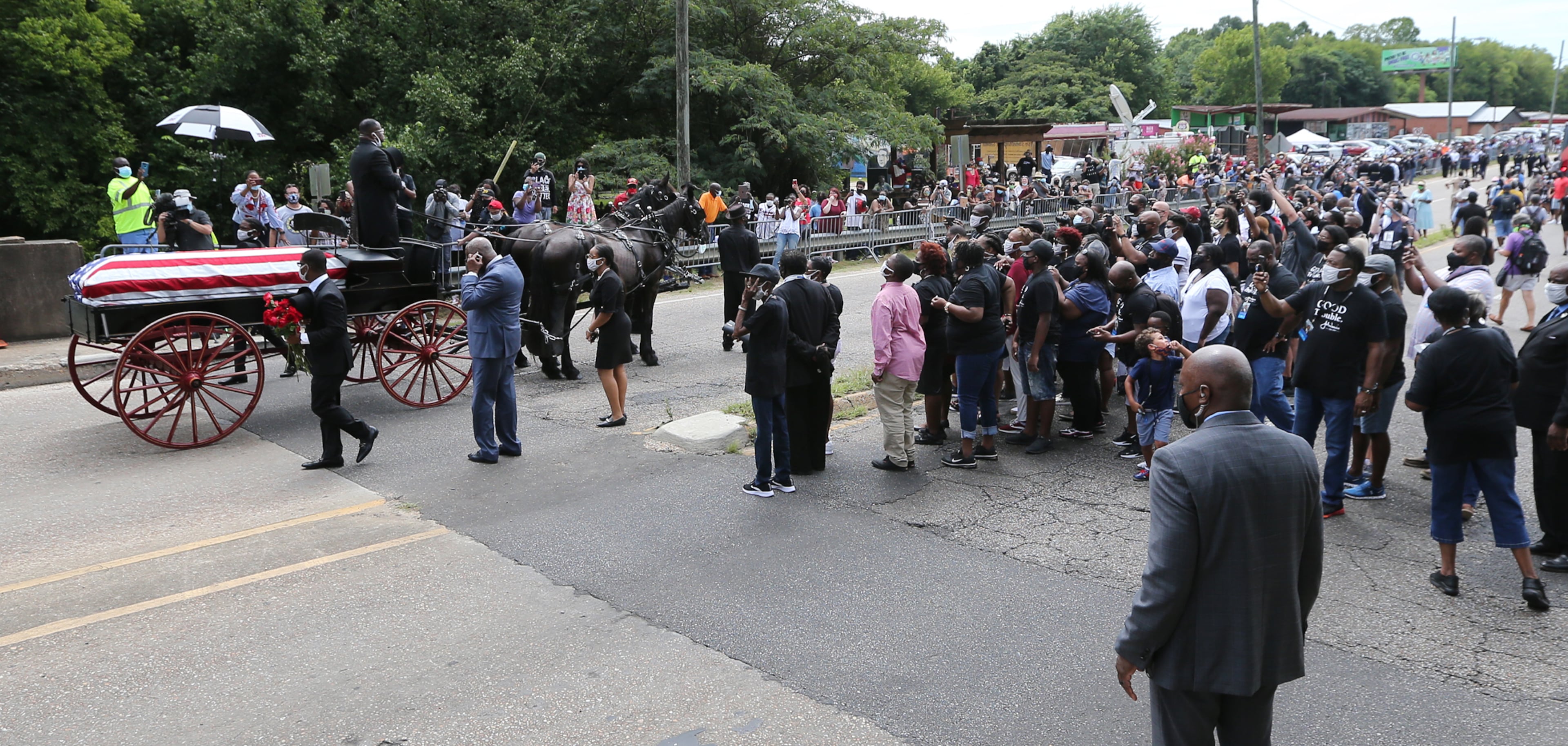 072620 Selma: A crowd looks on as the body of Rep. John Lewis concludes the final crossing over the Edmund Pettus Bridge, site of the historic 1965 voting rights marches, on Sunday, July 26, 2020 in Selma. The congressman from Georgia and civil rights icon died July 17 at age 80 after a battle with pancreatic cancer. Curtis Compton ccompton@ajc.com