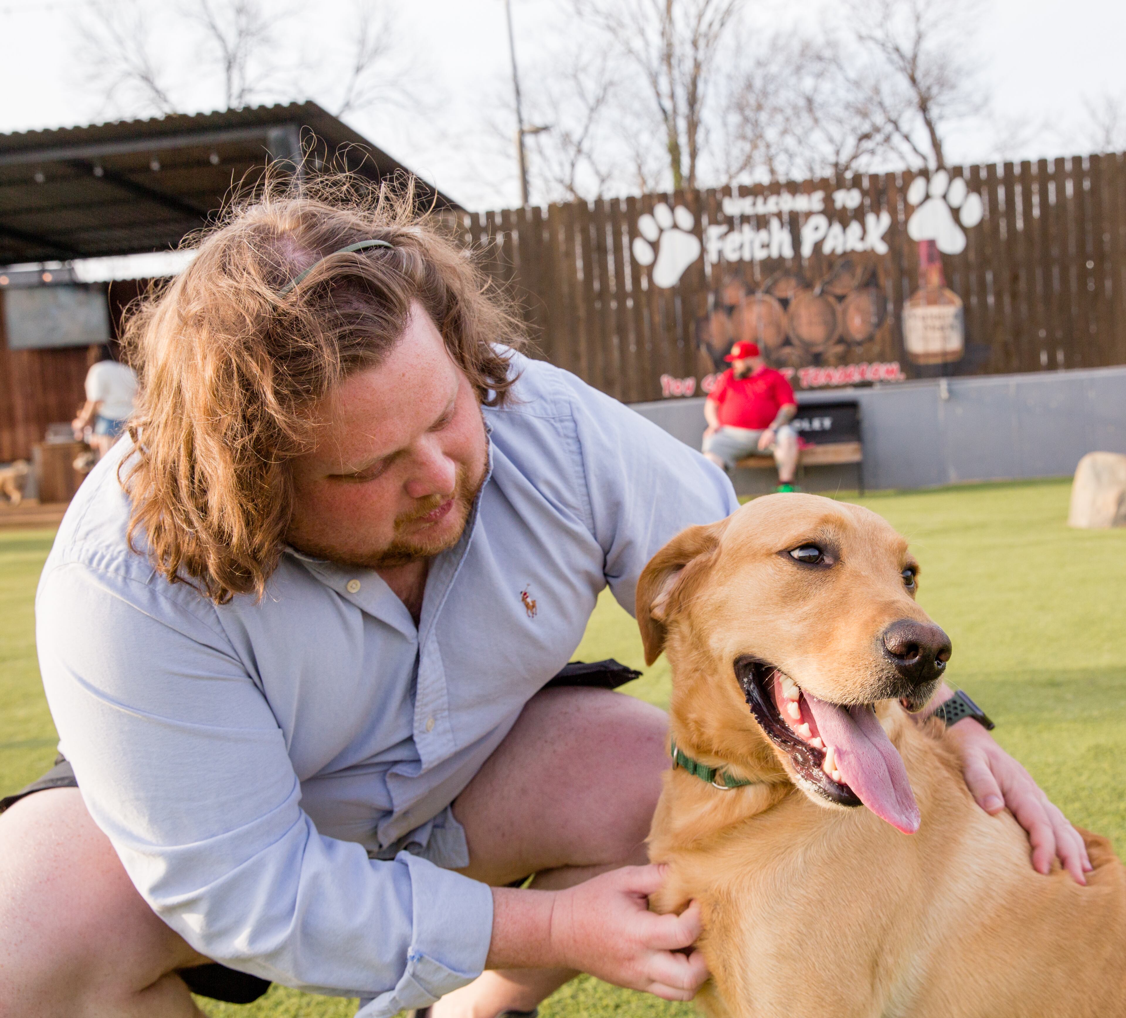Matt Matuszewski and his yellow lab Murphy play at Fetch Park at Boulevard and DeKalb Ave on Friday, March 12, 2021. (Jenni Girtman for The Atlanta Journal-Constitution)