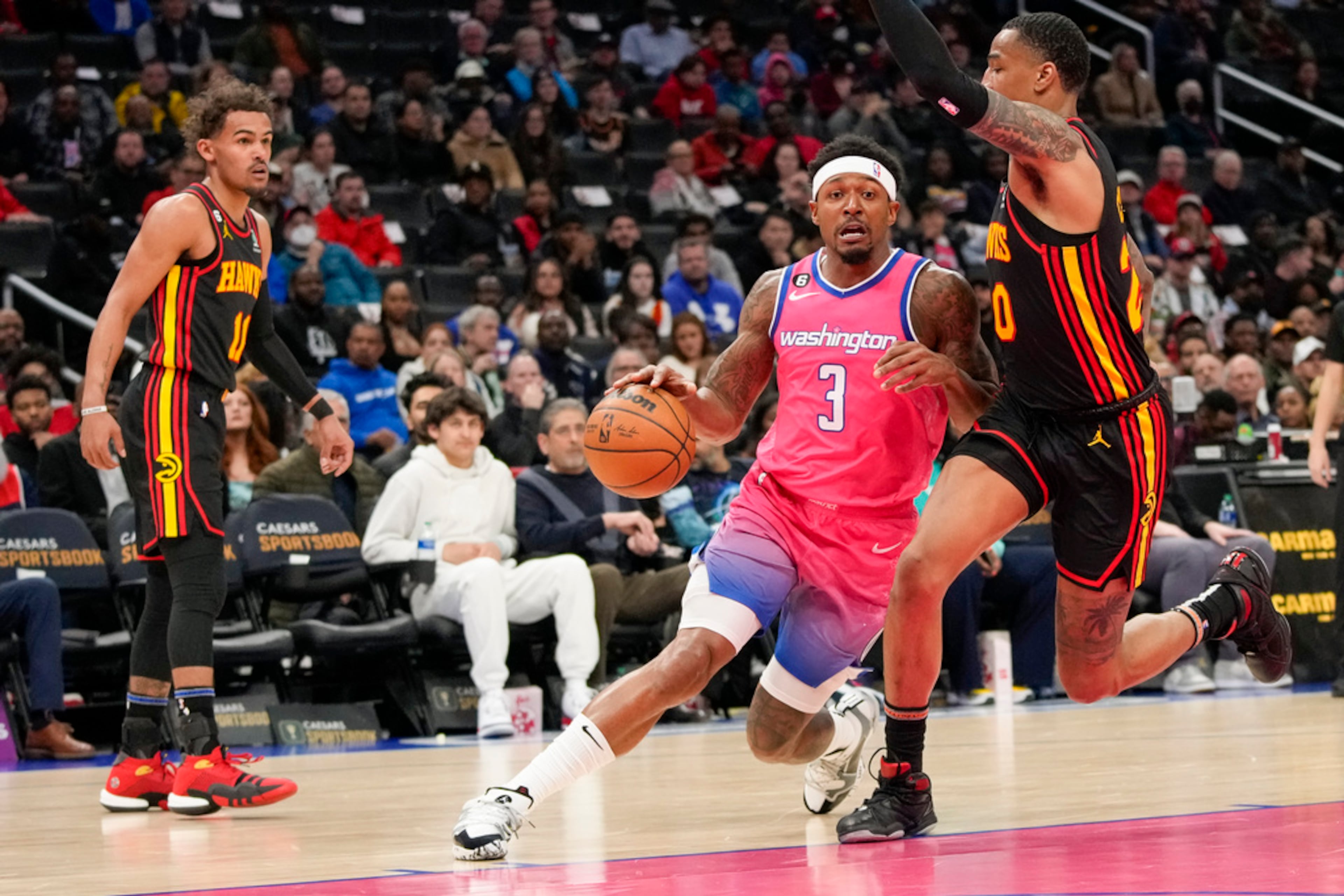 Washington Wizards guard Bradley Beal (3) drives past Atlanta Hawks forward John Collins (20) during the first half of an NBA basketball game Wednesday, March 8, 2023, in Washington. (AP Photo/Alex Brandon)