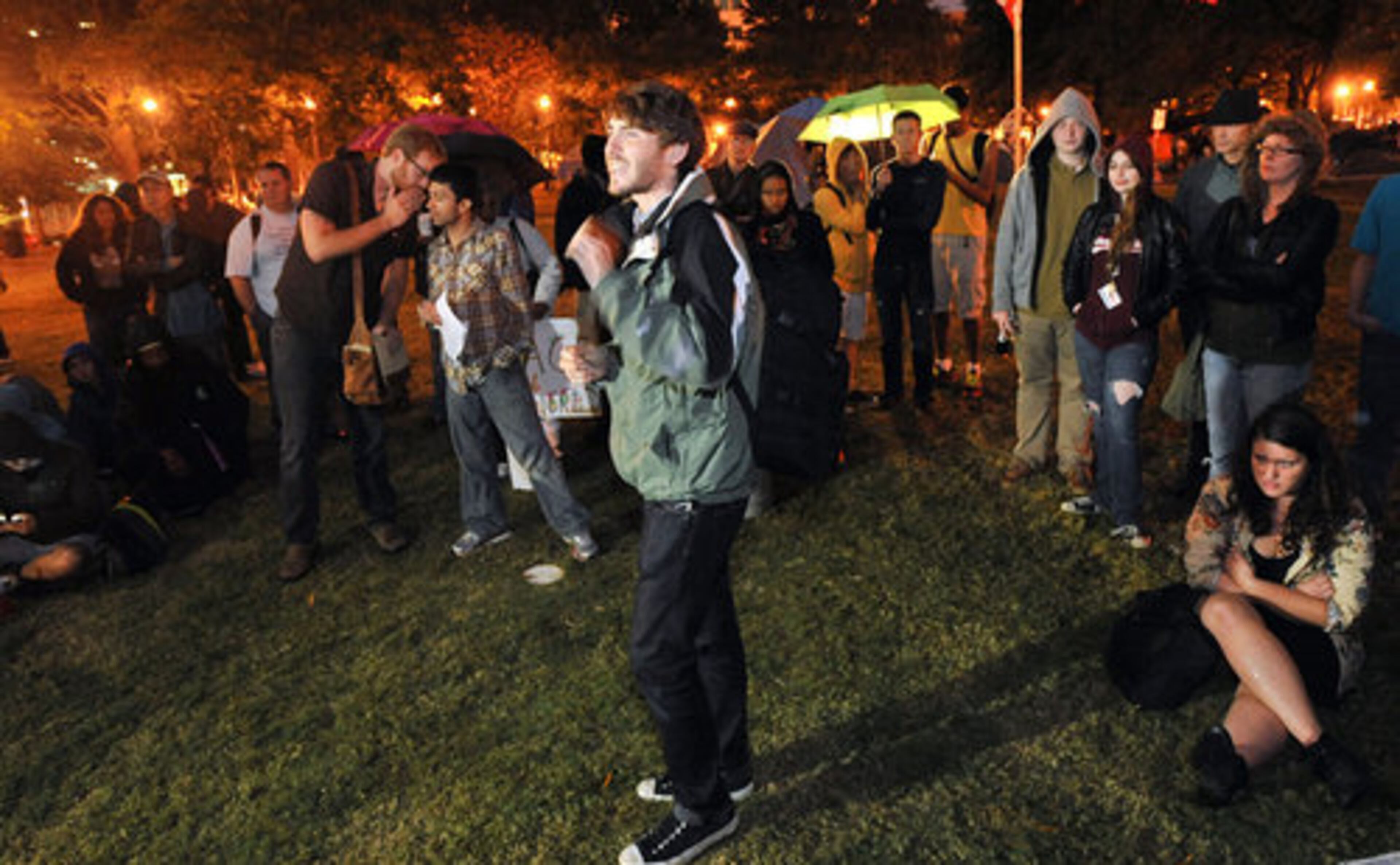Occupy Atlanta participant John Reynolds (center), of Atlanta, speaks during a general assembly in Woodruff Park on Thursday night.