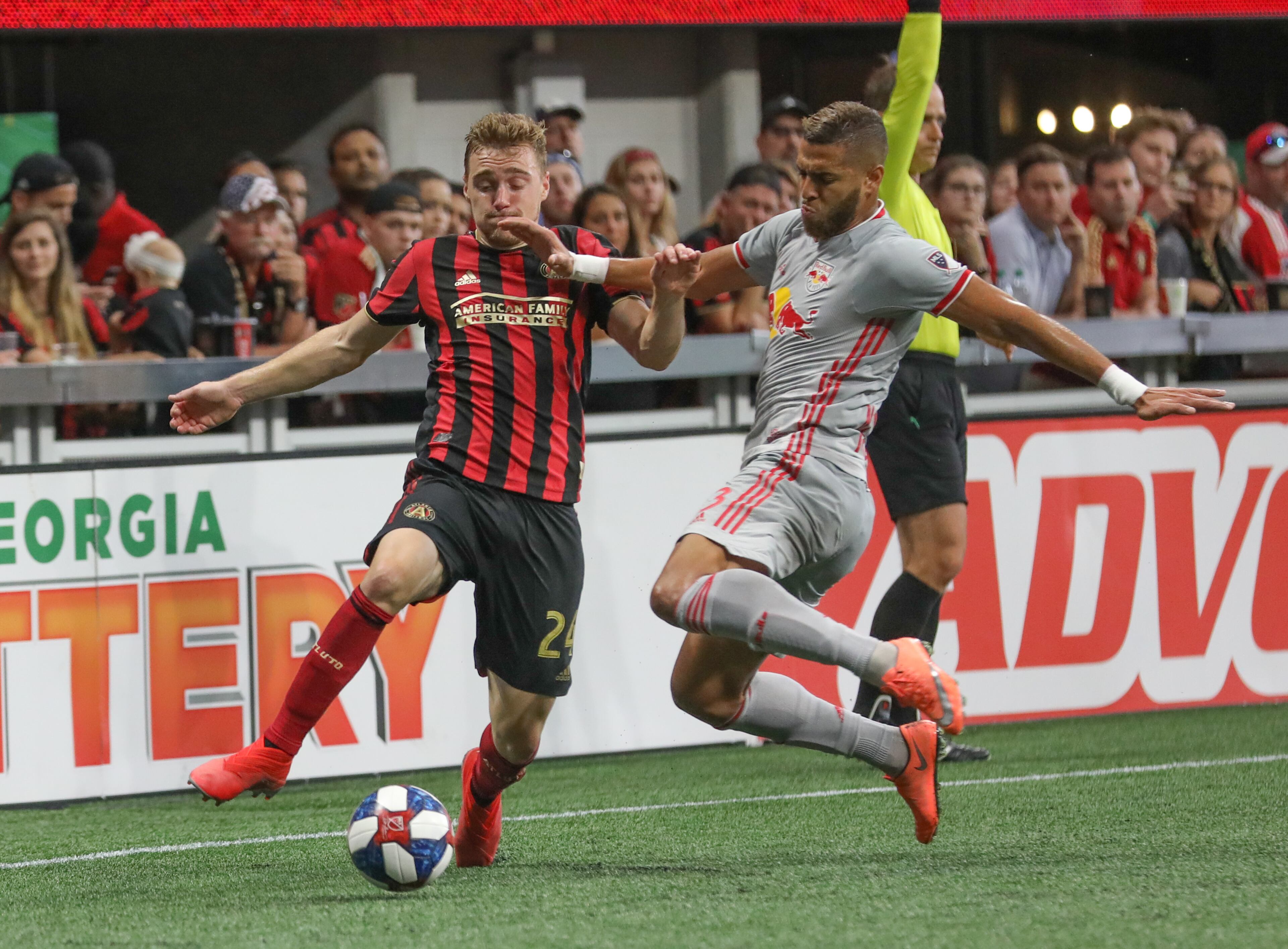 Atlanta United defender Julian Gressel (24) moves the ball past New York Red Bulls defender Amro Tarek (3) during the first half in a MLS game on Sunday, July 7, 2019, in Atlanta. BRANDEN CAMP/SPECIAL