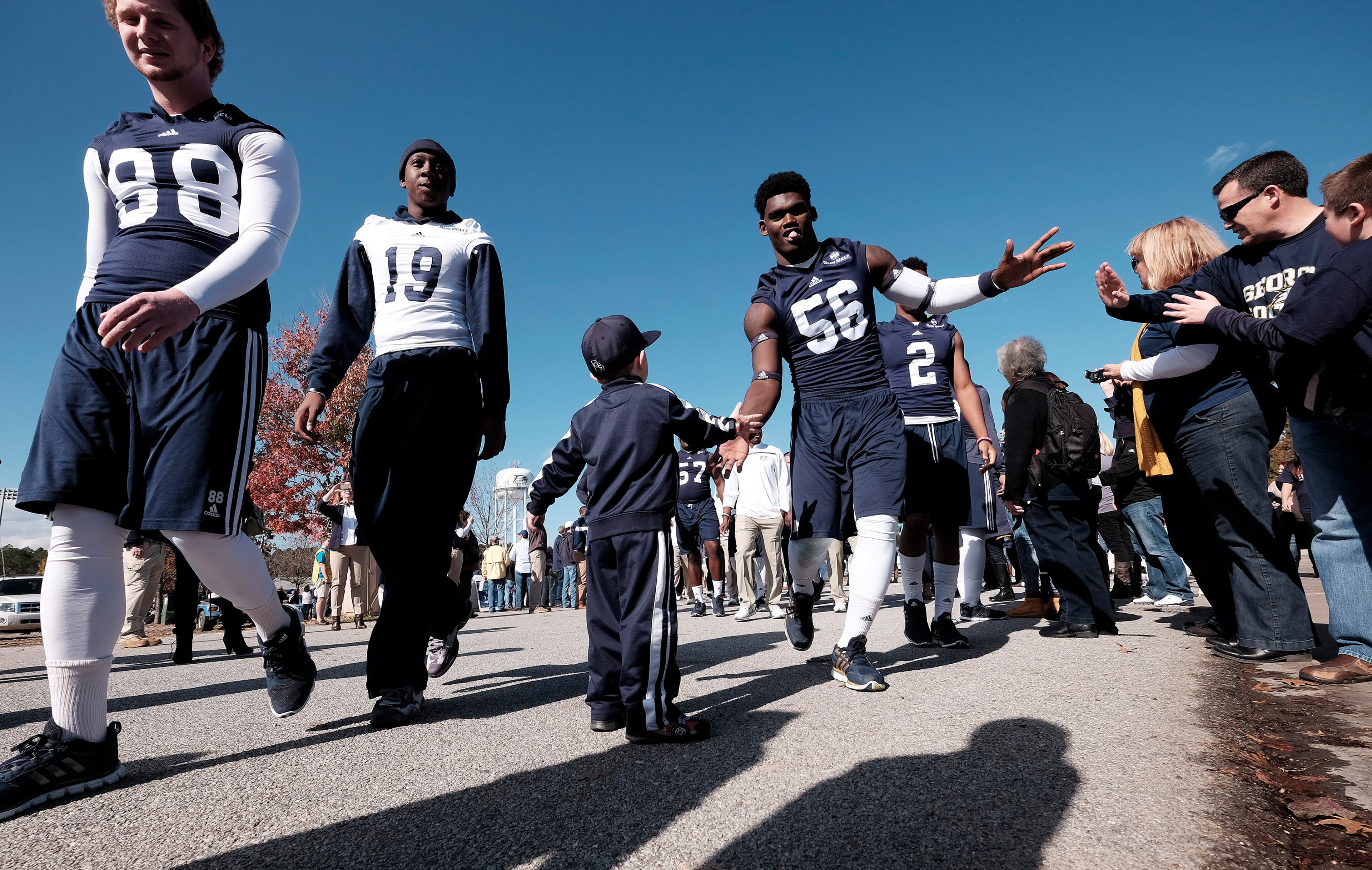 STATESBORO, GA - DECEMBER 5: Players for the Georgia Southern Eagles greet fans during the Eagle Walk before their game against the Georgia State Panthers on December 5, 2015 at Paulson Stadium in Statesboro, Georgia. (Photo by Todd Bennett/Getty Images)