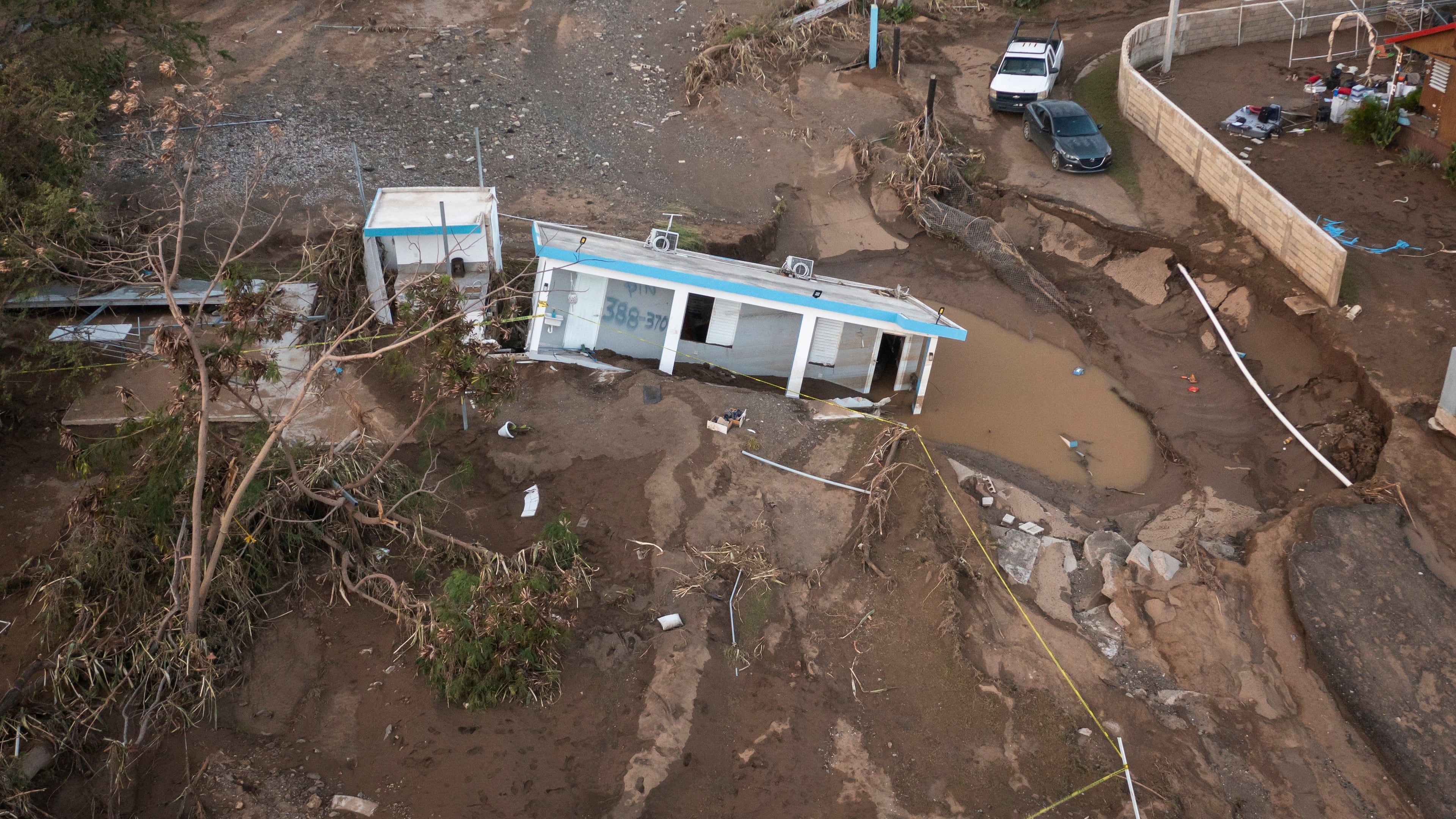 FILE - A house lays in the mud after it was washed away by Hurricane Fiona at Villa Esperanza in Salinas, Puerto Rico, Sept. 21, 2022. (AP Photo/Alejandro Granadillo)