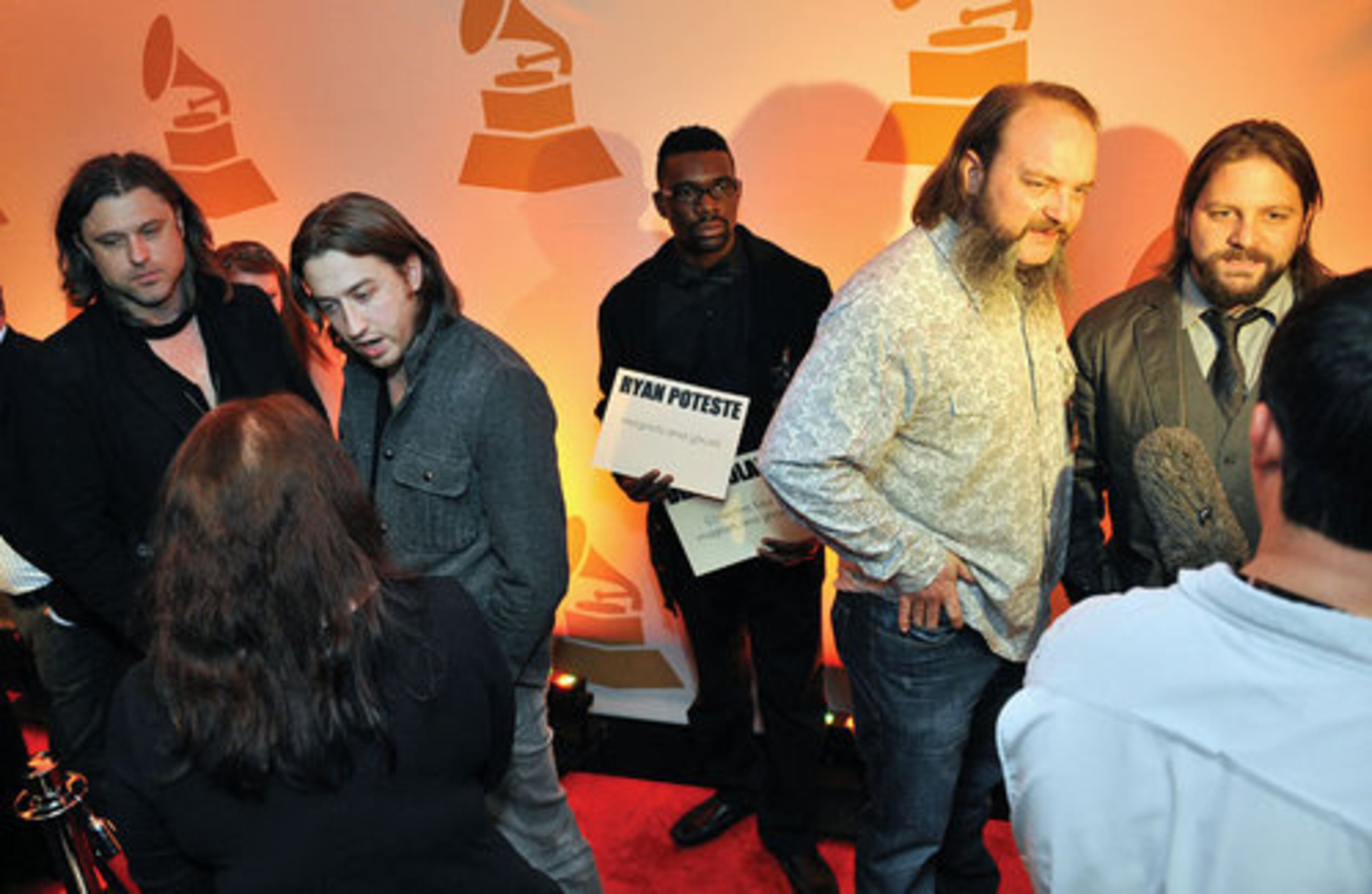 Dean Roland (from left) of Collective Soul and Ryan Poteste, John Hopkins and Coy Bowles, both members of Zac Brown band speak to members of the media on the red carpet at the Atlanta chapter of the Recording Academy's Grammy nominees party at W Atlanta - Downtown.