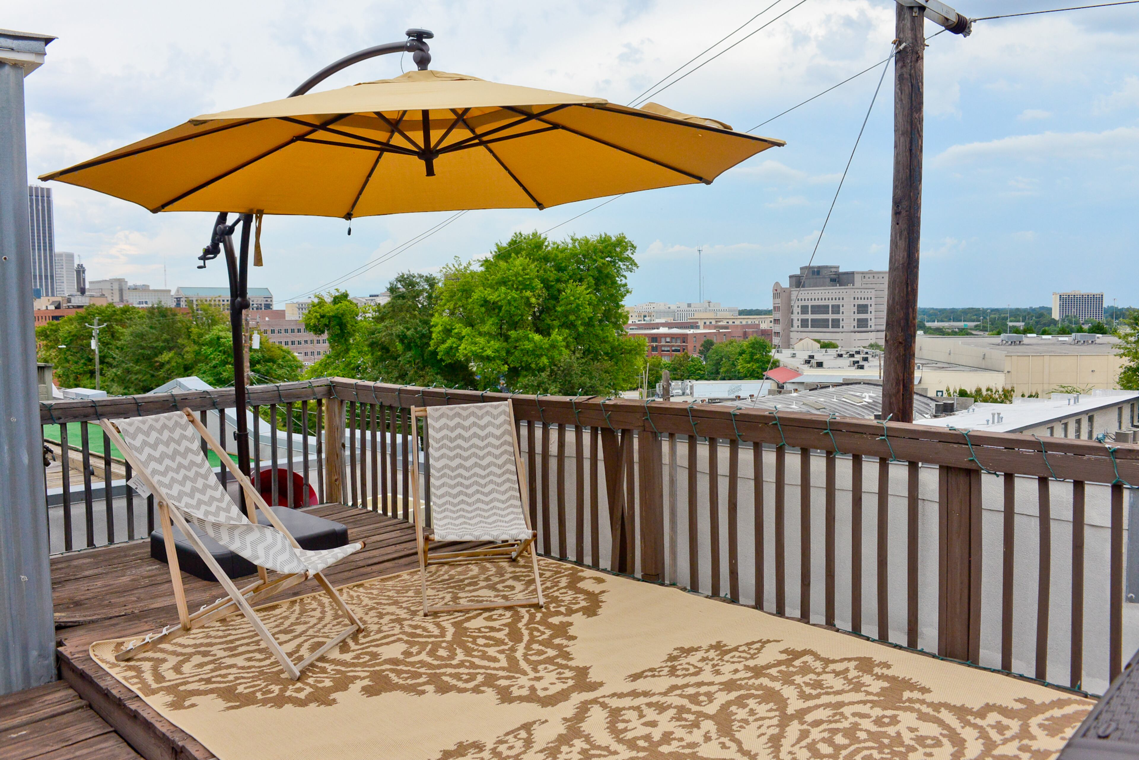 The Giels often escape to their loft's rooftop deck to enjoy a wide view of their Castleberry Hill neighborhood. They have outfitted the space with furniture from Ikea and a rug by nuLOOM.