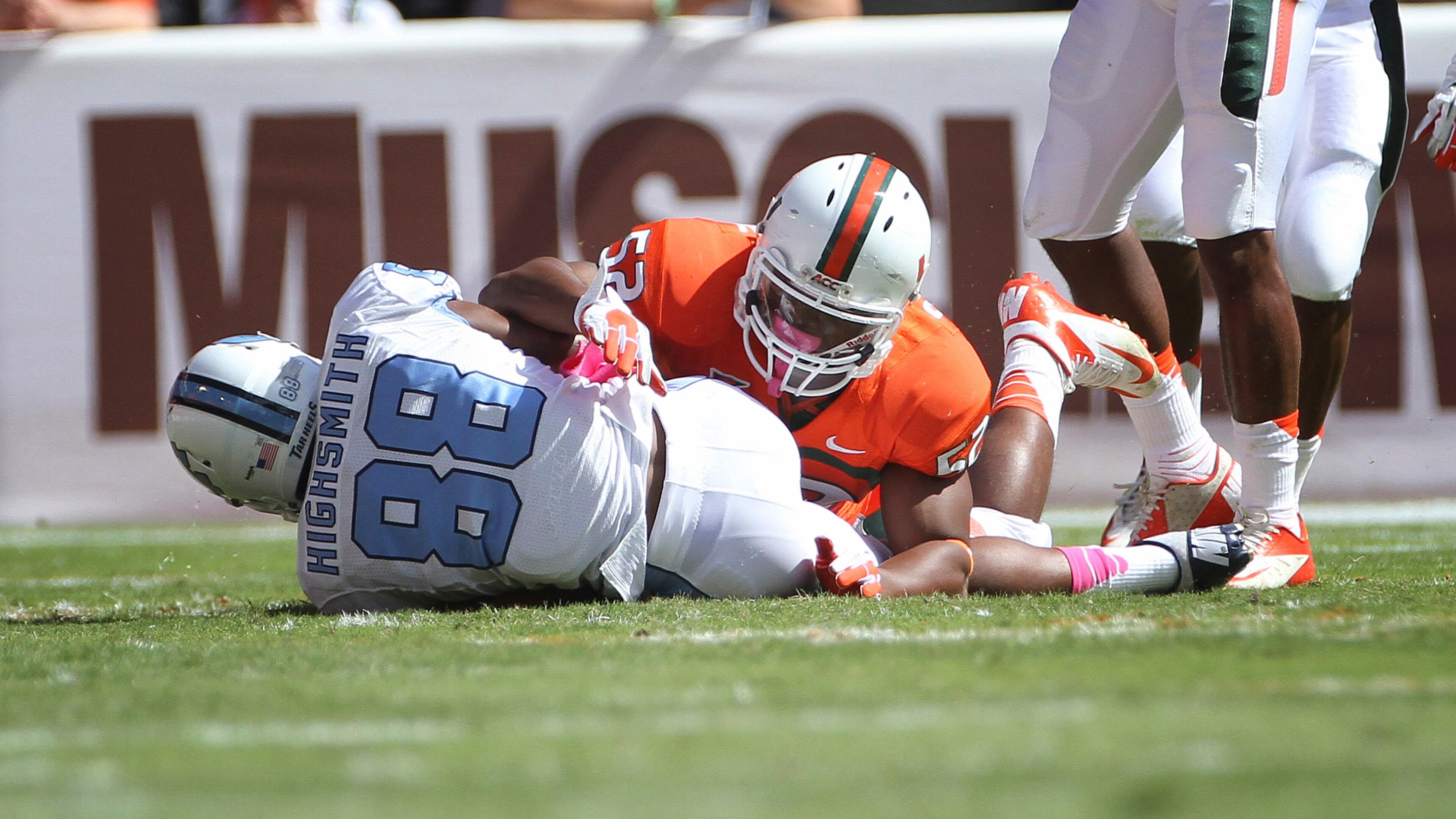 Miami's Denzel Perryman (52) tackles North Carolina's Erik Highsmith (88) during the first half of a NCAA college football game in Miami, Saturday, Oct. 13, 2012. (AP Photo/J Pat Carter)