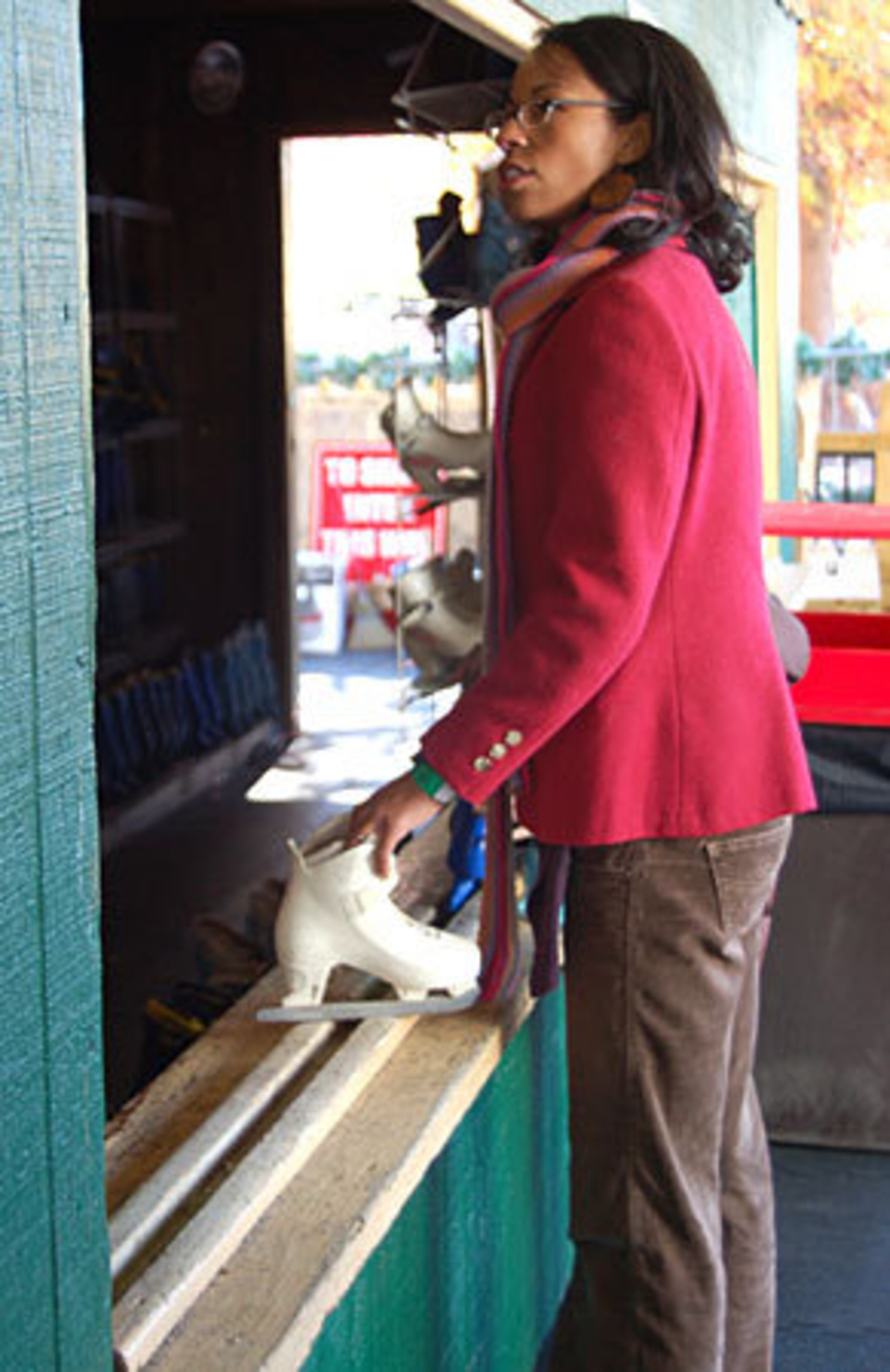 Ashley Rouse, from Atlanta, waited to get her other ice skate at the skate rental at Centennial Park. She came with her whole family and said she enjoyed watching her children learn how to ice skate.