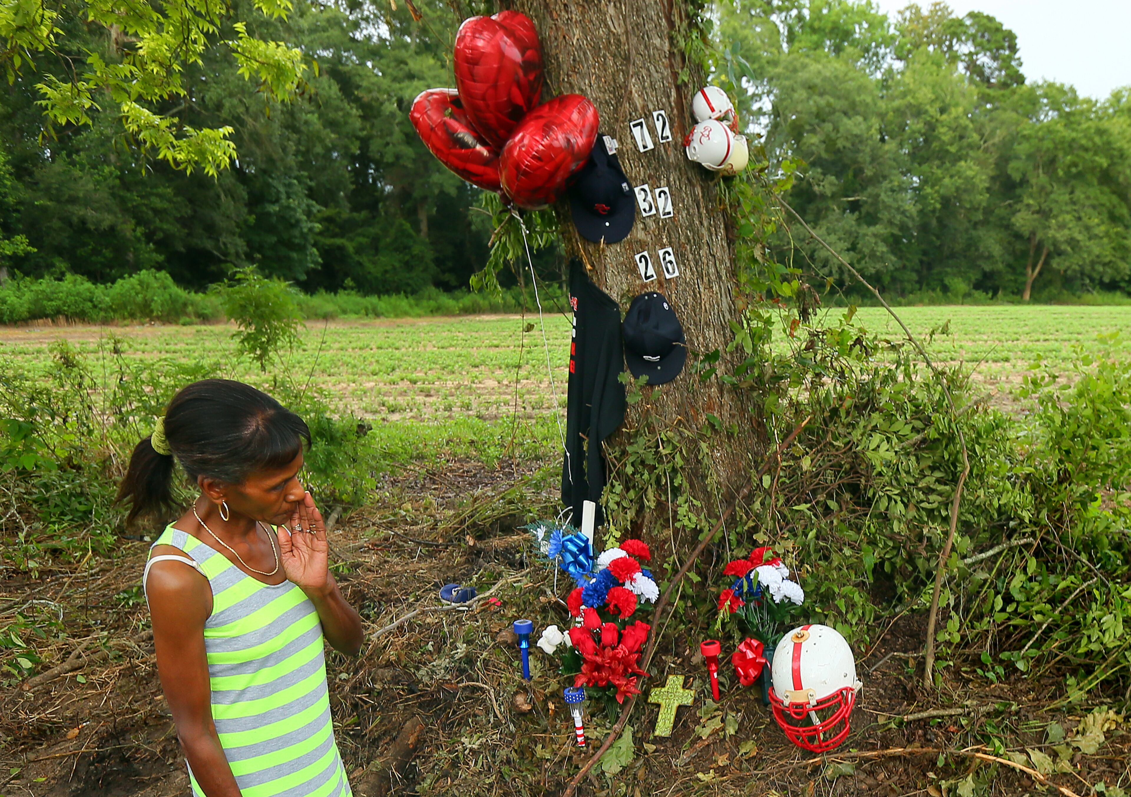 Carolyn Whitfield grieves for her grandson Shawn Waters visiting the site where three Brooks County High School football players were killed in a rollover crash.