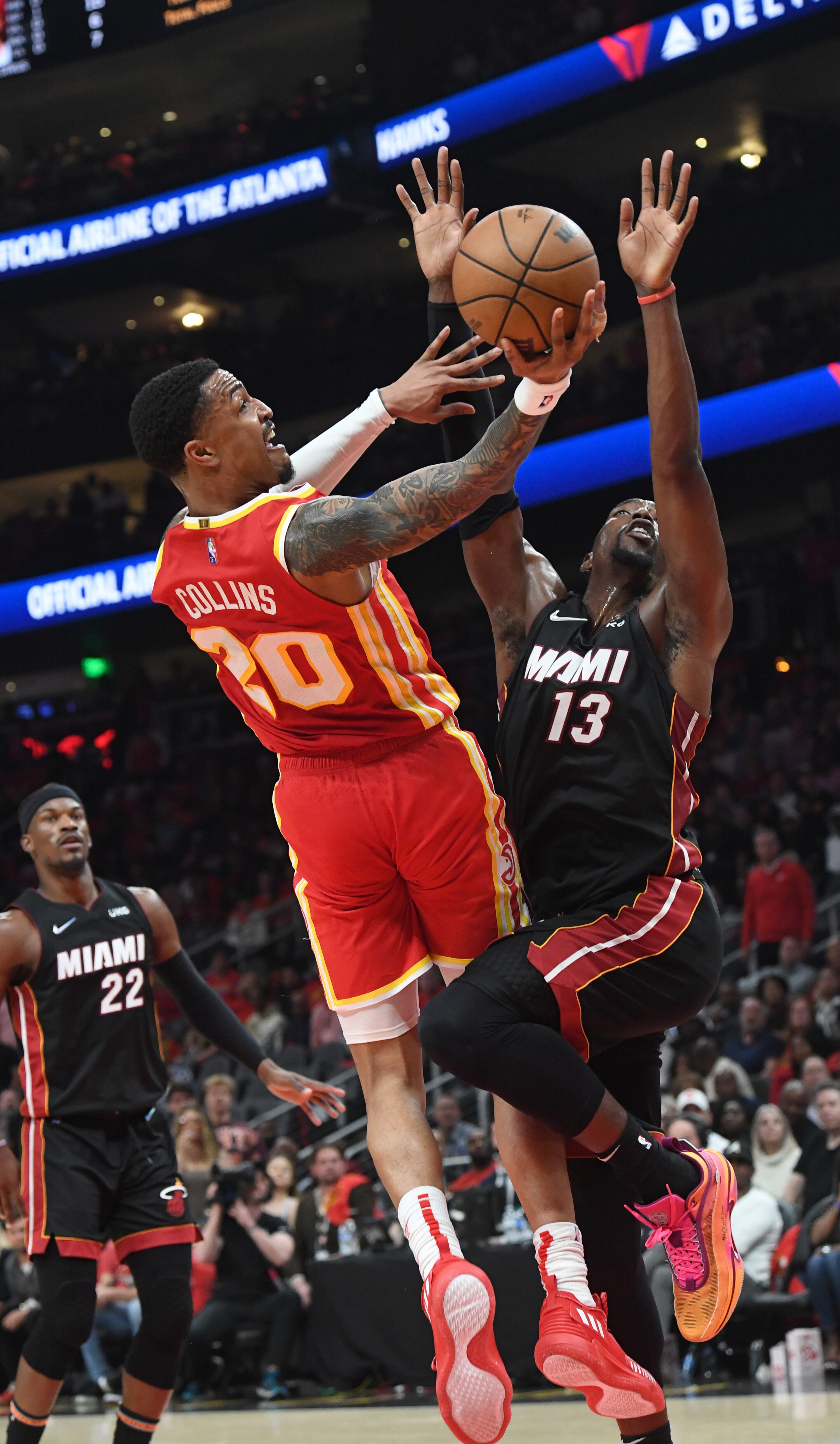 April 22, 2022 Atlanta - Atlanta Hawks' forward John Collins (20) goes in for a lay-up against Miami Heat's center Bam Adebayo (13) during the first half in Game 3 of the first round of the NBA playoffs at State Farm Arena on Friday, April 22, 2022. (Hyosub Shin / Hyosub.Shin@ajc.com)