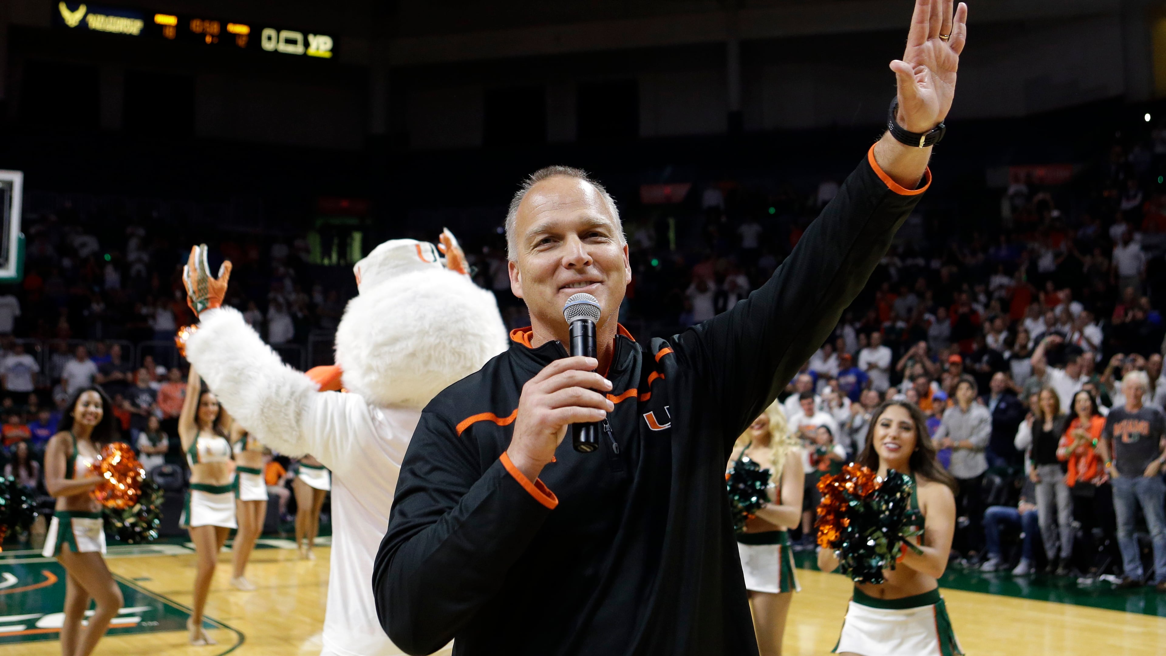 University of Miami football coach Mark Richt waves to the fans after being introduced during an NCAA basketball game between Miami and Florida, Tuesday, Dec. 8, 2015, in Coral Gables, Fla. (AP Photo/Alan Diaz)
