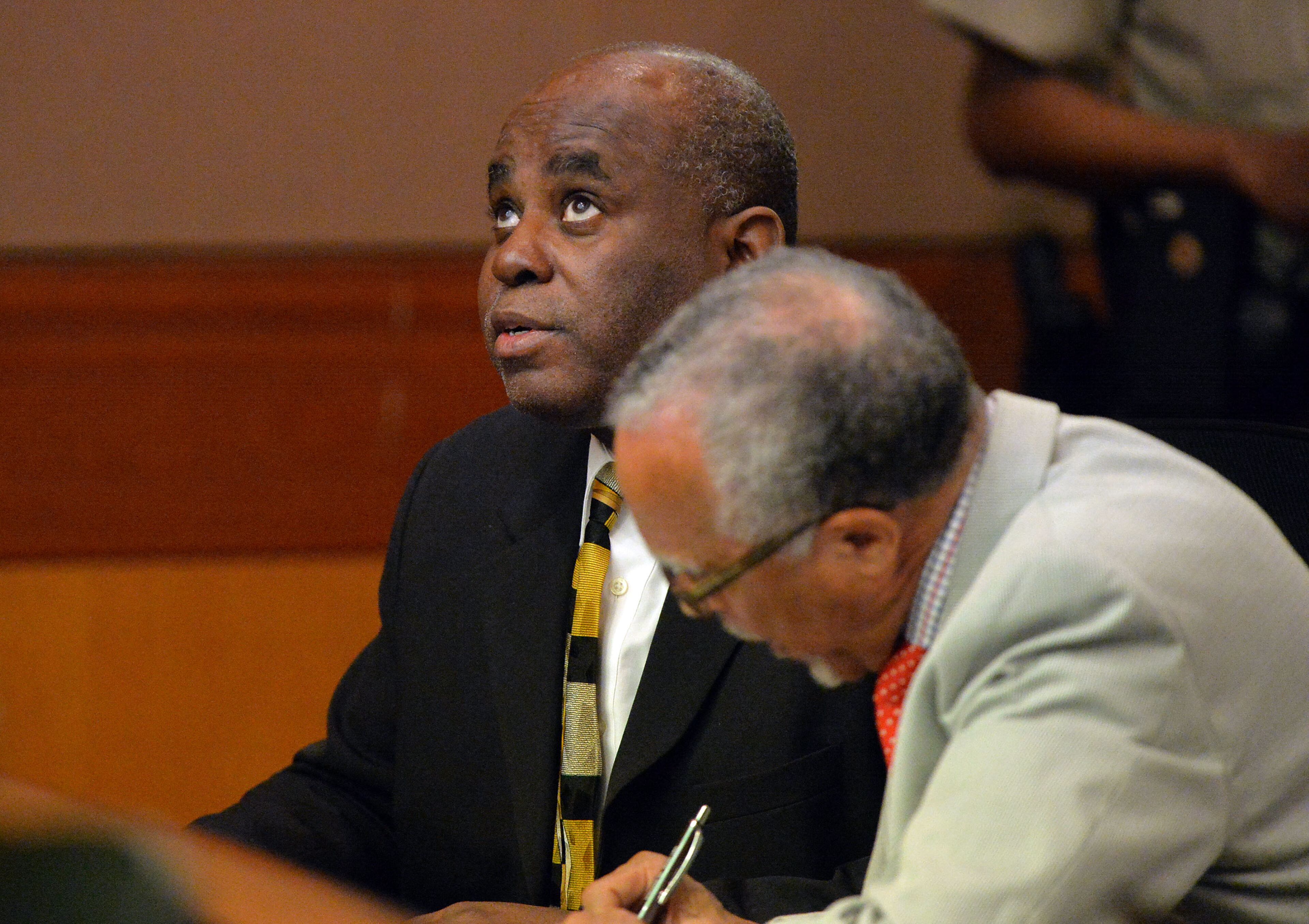 Former APS Usher Collier Heights Elem testing coordinator Donald Bullock looks skyward and utters a small prayer as his defense attorney Hurl Taylor looks over a sentencing deal for 5 years probation, 6 months of weekends in jail, $5000 fine and 1500 hours of community service. Sentencing continues for 10 of the 11 defendants convicted of racketeering and other charges in the Atlanta Public Schools test-cheating trial before Judge Jerry Baxter in Fulton County Superior Court, Tuesday, April 14, 2015. (Atlanta Journal-Constitution, Kent D. Johnson, Pool)