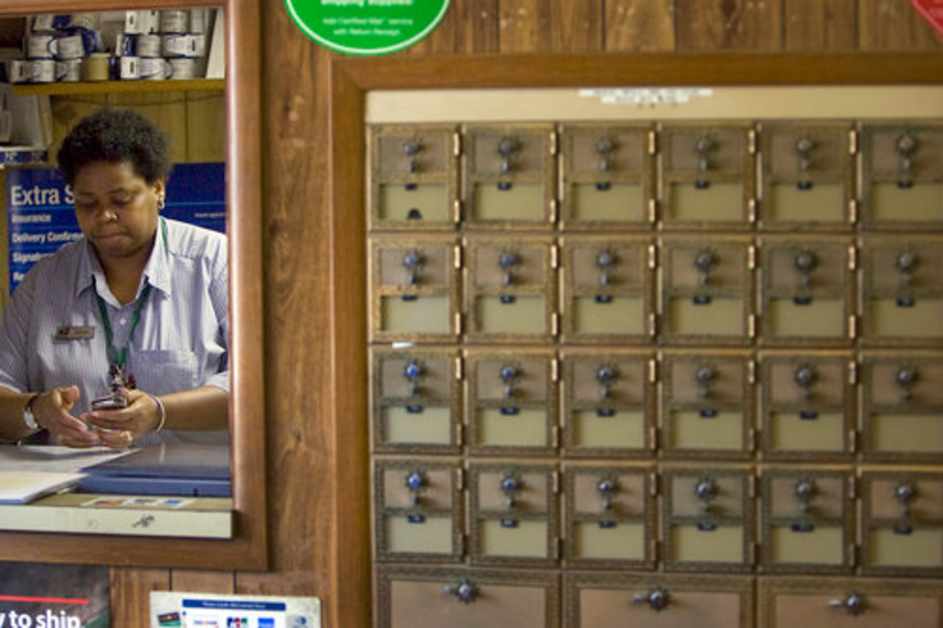 Postmaster Joyce Macfoy readies to close her office promptly at 3:30p each weekday.