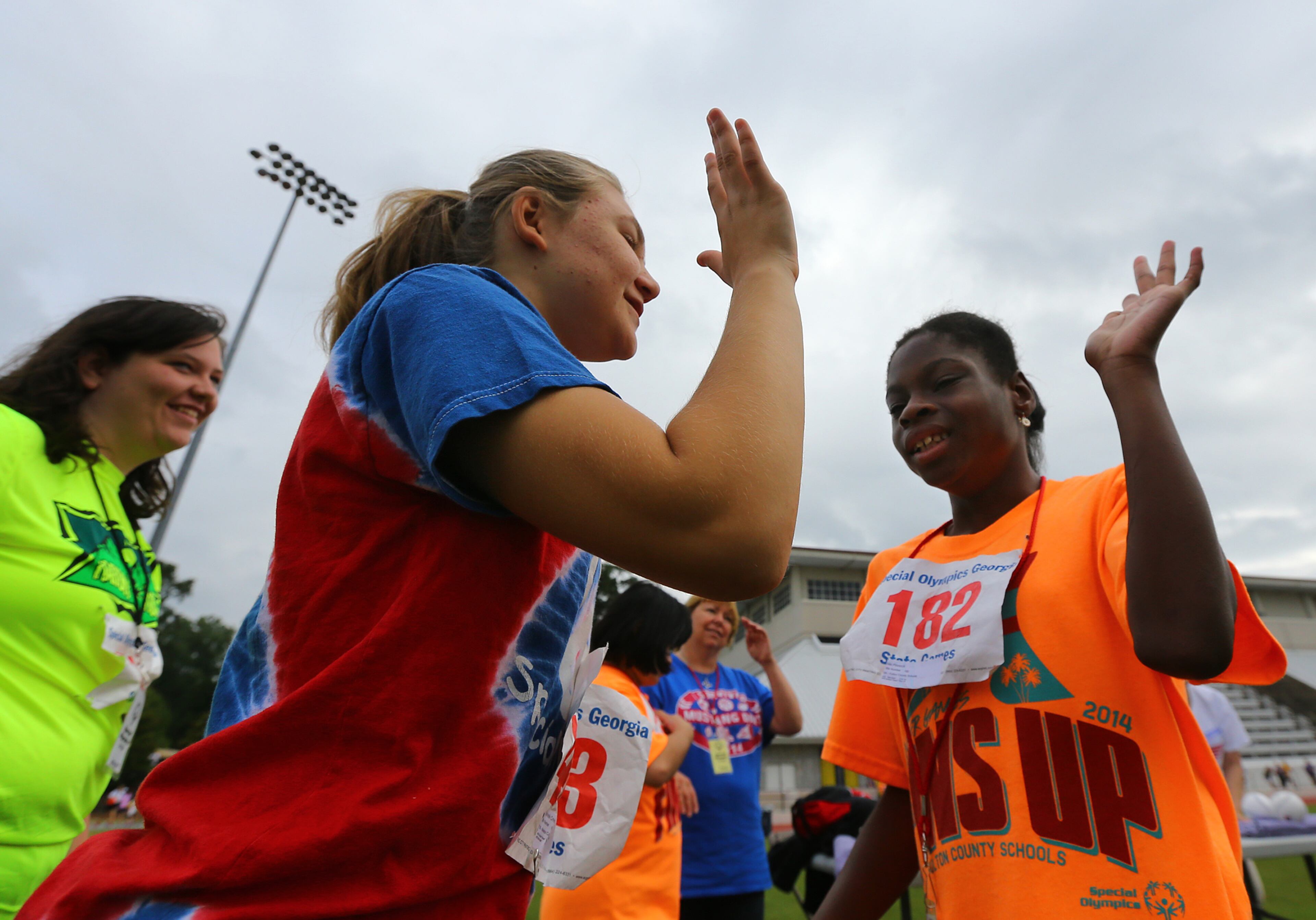 Gabrielle Crews (left), 13, Covington, gives her competitor Nia Pinnock (right), 12, Fulton County Schools, a high five after her toss in the softball throw during the Special Olympics Georgia State Summer Games at Emory University on Sunday, June 1, 2014, in Atlanta. Crews took home the silver medal and Pinnock the bronze.