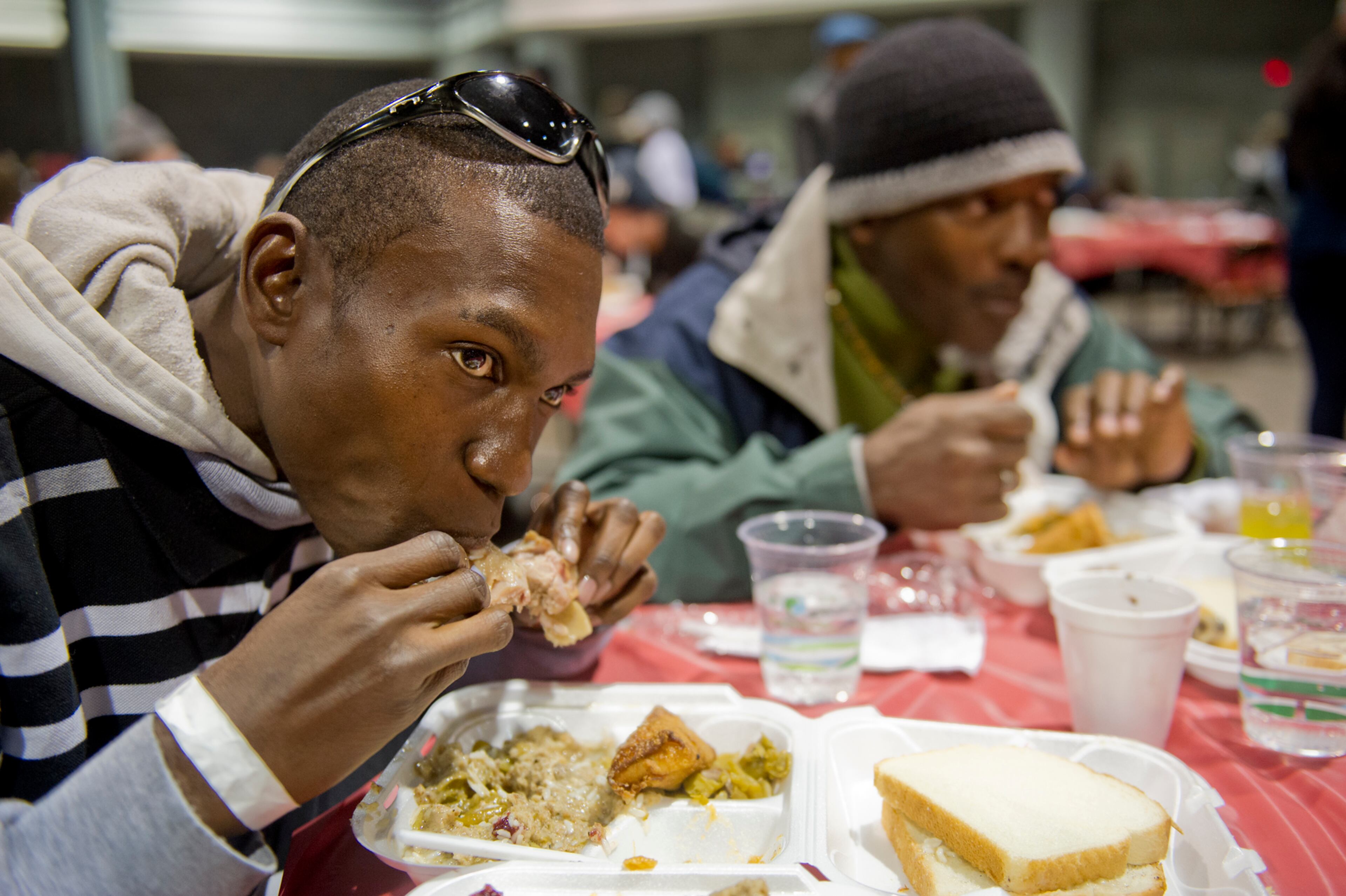 Charles Agim (left) and Stanley Brown eat a five-course Thanksgiving meal during the Hosea Feed the Hungry and Homeless annual Thanksgiving meal at the Georgia World Congress Center in Atlanta on Nov. 28, 2013.