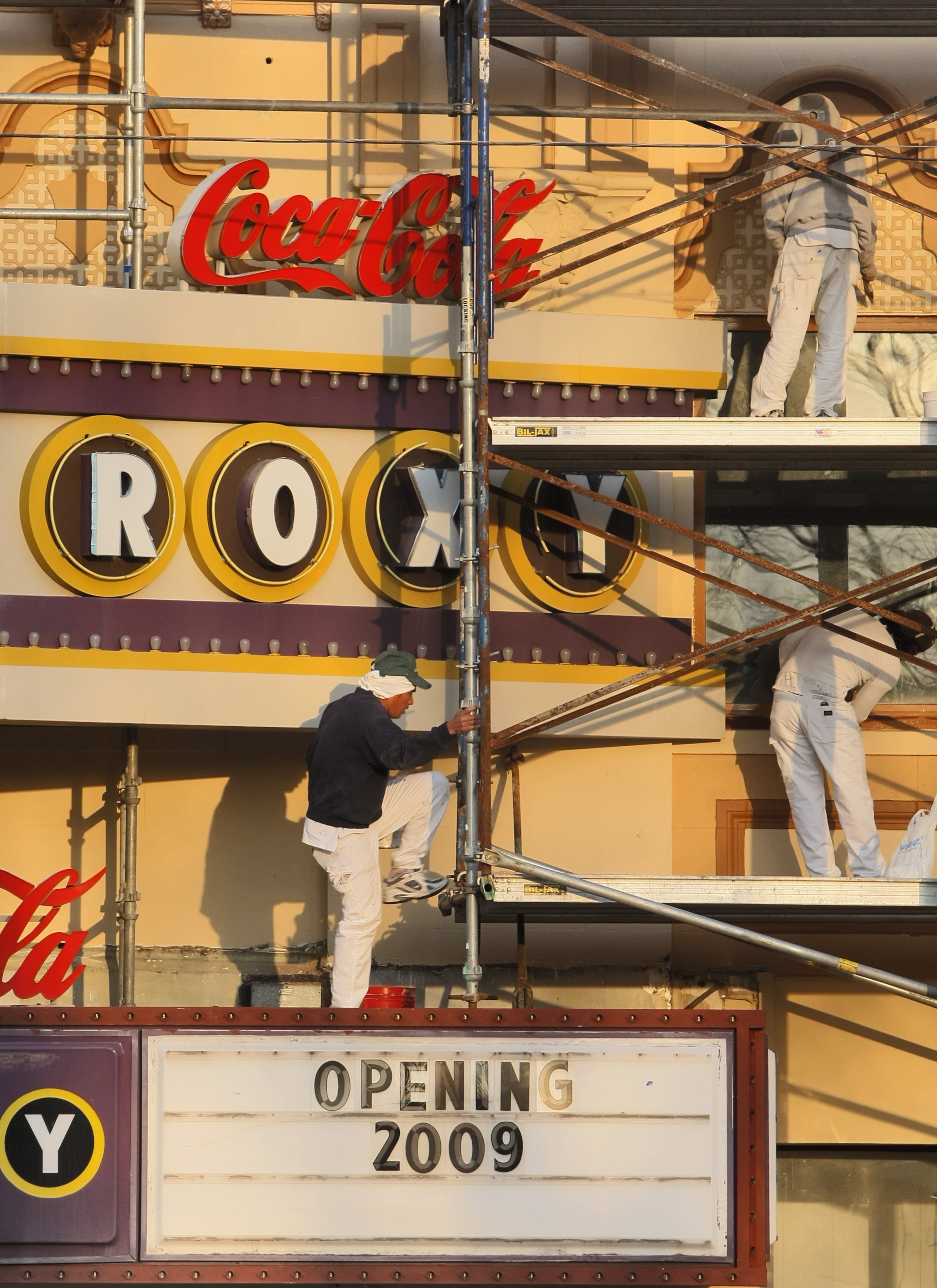 090312 - Atlanta - The early morning sun left a golden glow across the painters covered the facade of the Coca-Cola Roxy Theater on scaffoldings Thursday, March 12, 2009 in Buckhead that closed last year. Contractors are doing and extensive renovation that should be completed in calendar year 2009. In 2006, Charlie Loudermilk bought properties in the 3100 Roswell Road block in Buckhead that included the Roxy Theater. The founder and CEO of Aaron Rents said at the time he planned to renovate it into an upscale arts and theater complex and upscale multipurpose venue. John Spink/jspink@ajc.com